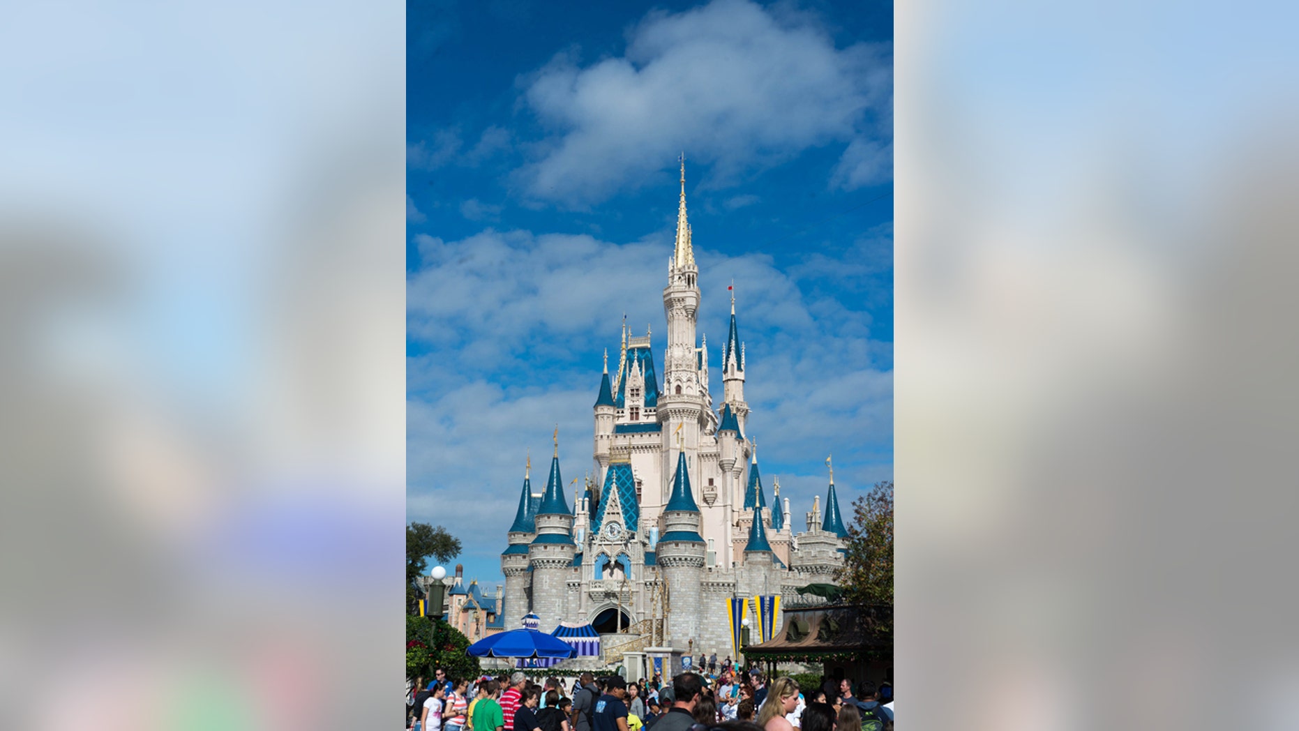 Orlando, Florida, USA. December 27,2014. Sunny day with Cinderella's Castle at Walt Disney World. Picture was taken on one of the busiest days of the year as evidenced by the crowd of people in front of the castle.