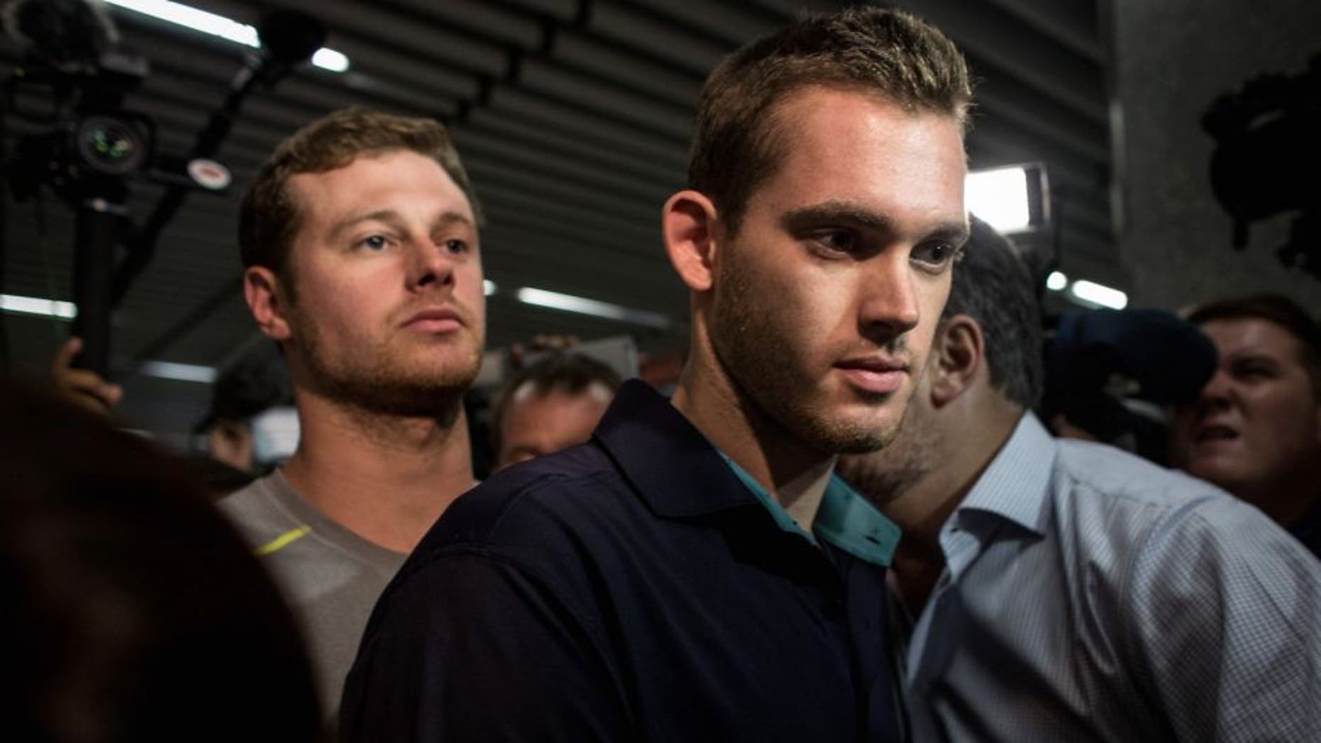 RIO DE JANEIRO, BRAZIL - AUGUST 18: U.S Olympic swimmers Gunnar Bentz and Jack Conger leave the police headquarters at International departures of Rio de Janiero's Galeo International airport on August 18, 2016 in Rio de Janiero, Brazil. The swimmers were removed from their flight departing for the United States by Brazilian authorities to give more information about a reported armed robbery earlier in the week which included fellow U.S swimmers Ryan Lochte and James Feign. (Photo by Chris McGrath/Getty Images)