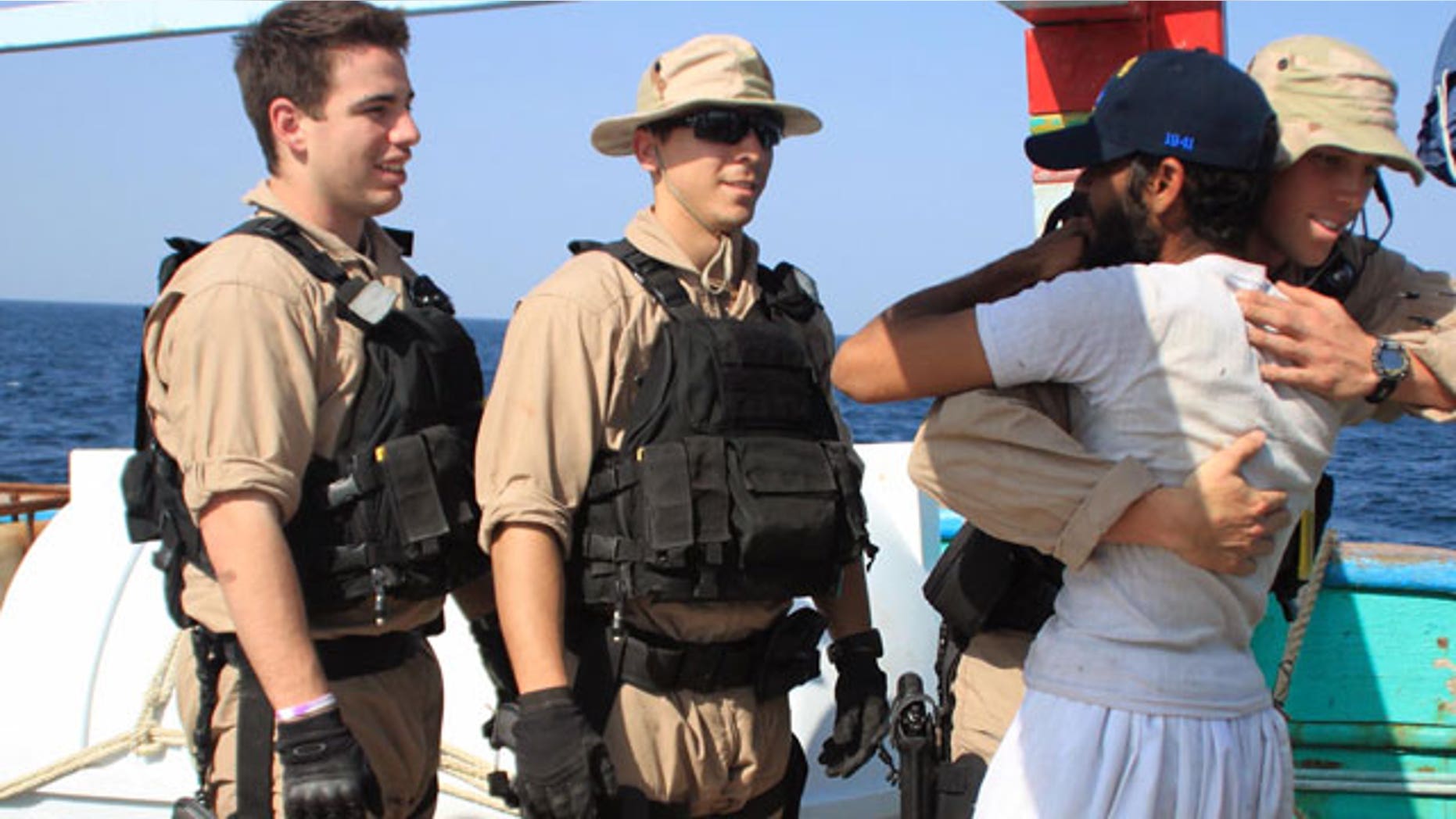 January 6, 2012: U.S. Navy sailors assigned to the guided-missile destroyer USS Kidd greet a crew member of the Iranian fishing vessel, the Al Molai Fin the Arabian Sea.