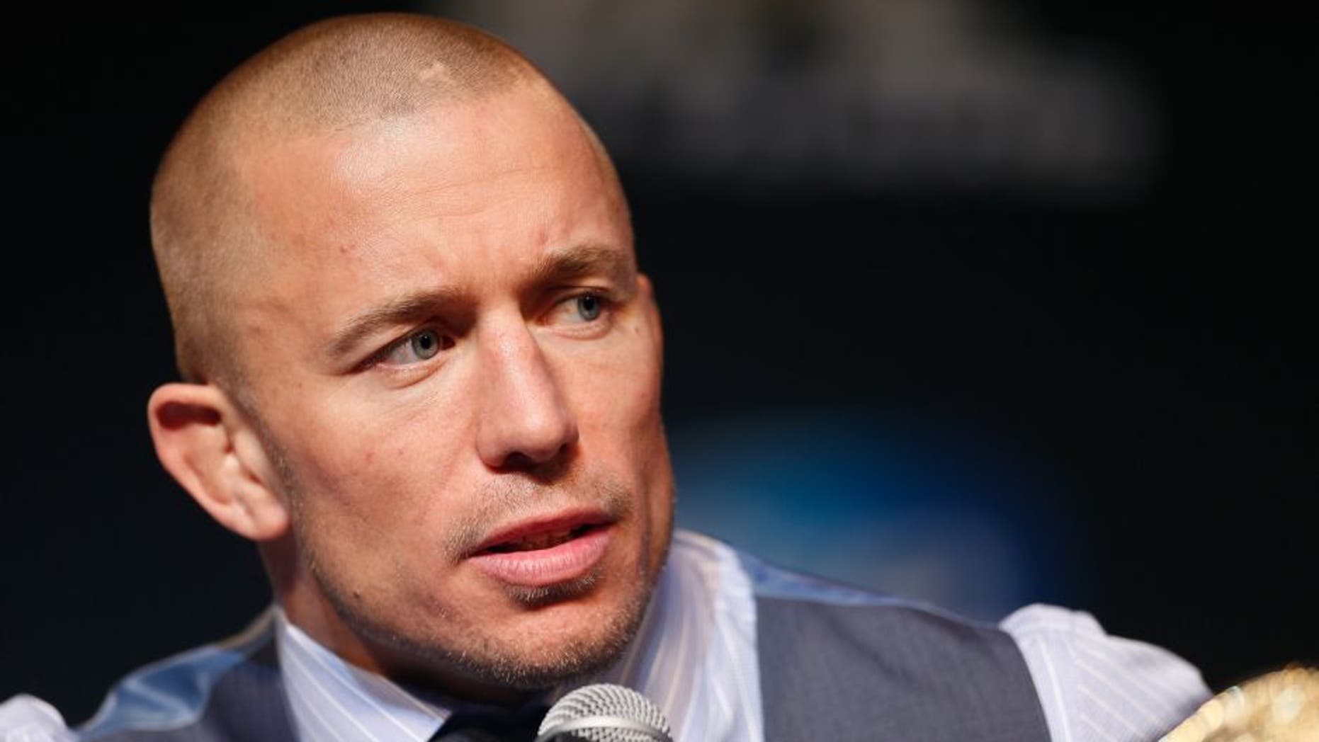 LAS VEGAS, NV - NOVEMBER 14: UFC welterweight champion Georges St-Pierre interacts with media during the final UFC 167 pre-fight press conference inside the Hollywood Theatre at the MGM Grand Hotel/Casino on November 14, 2013 in Las Vegas, Nevada. (Photo by Josh Hedges/Zuffa LLC/Zuffa LLC via Getty Images)