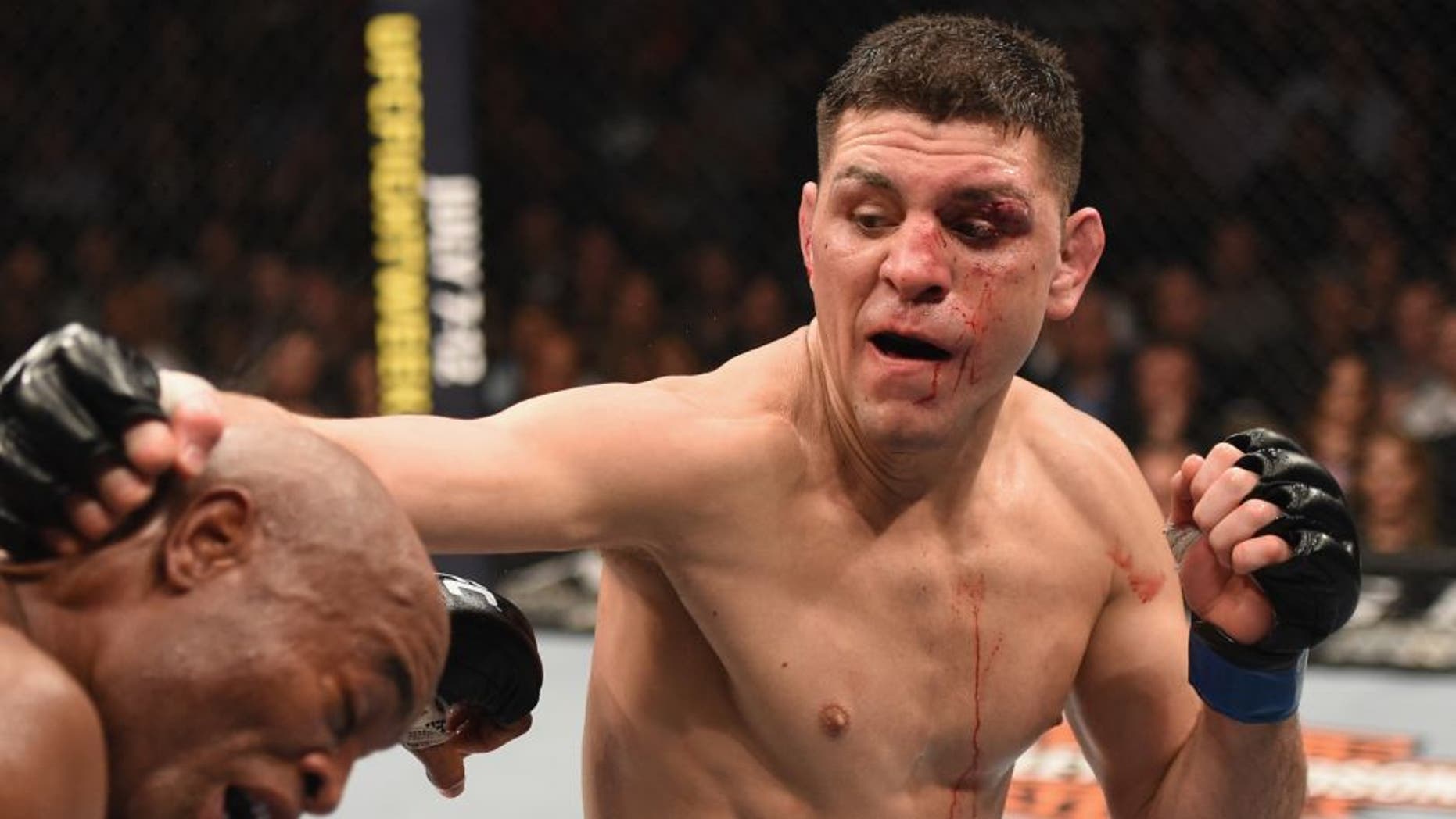 LAS VEGAS, NV - JANUARY 31: (R-L) Nick Diaz punches Anderson Silva of Brazil in their middleweight bout during the UFC 183 event at the MGM Grand Garden Arena on January 31, 2015 in Las Vegas, Nevada. (Photo by Josh Hedges/Zuffa LLC/Zuffa LLC via Getty Images)