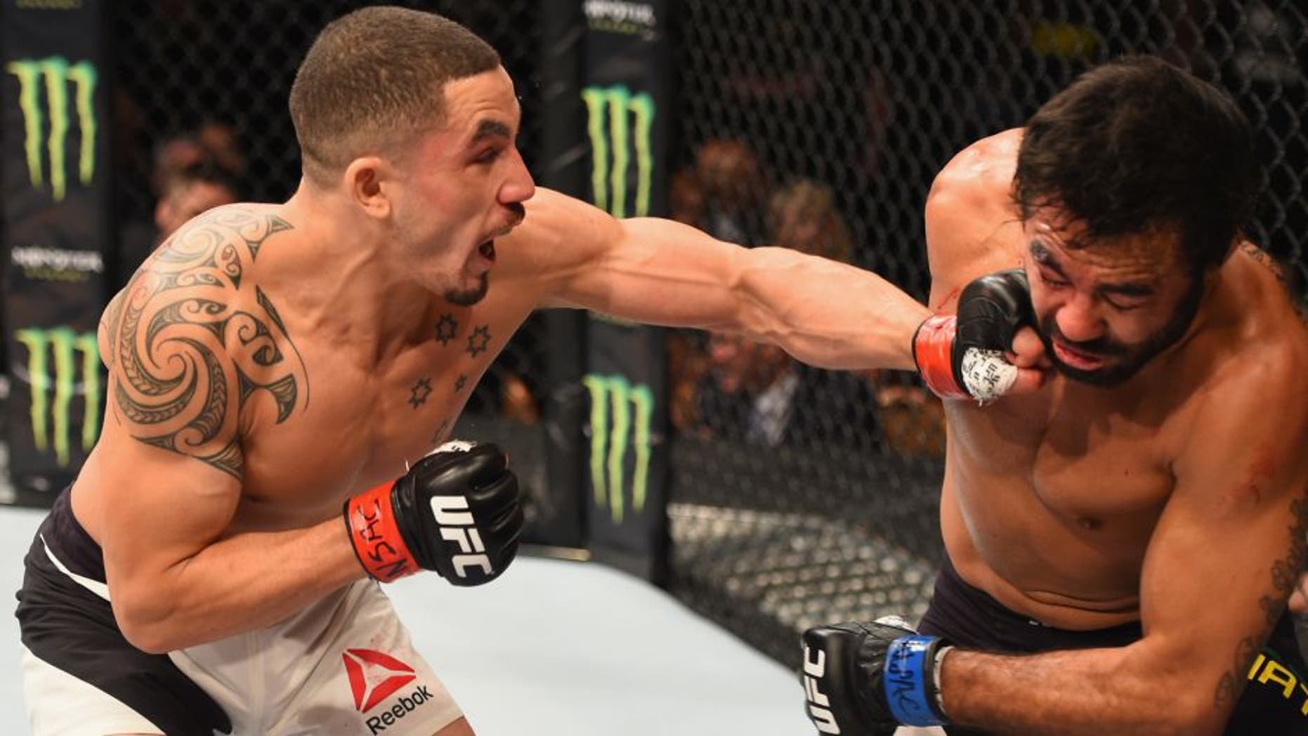 LAS VEGAS, NV - APRIL 23: (L-R) Robert Whittaker of New Zealand punches Rafael Natal in their middleweight bout during the UFC 197 event inside MGM Grand Garden Arena on April 23, 2016 in Las Vegas, Nevada. (Photo by Josh Hedges/Zuffa LLC/Zuffa LLC via Getty Images)