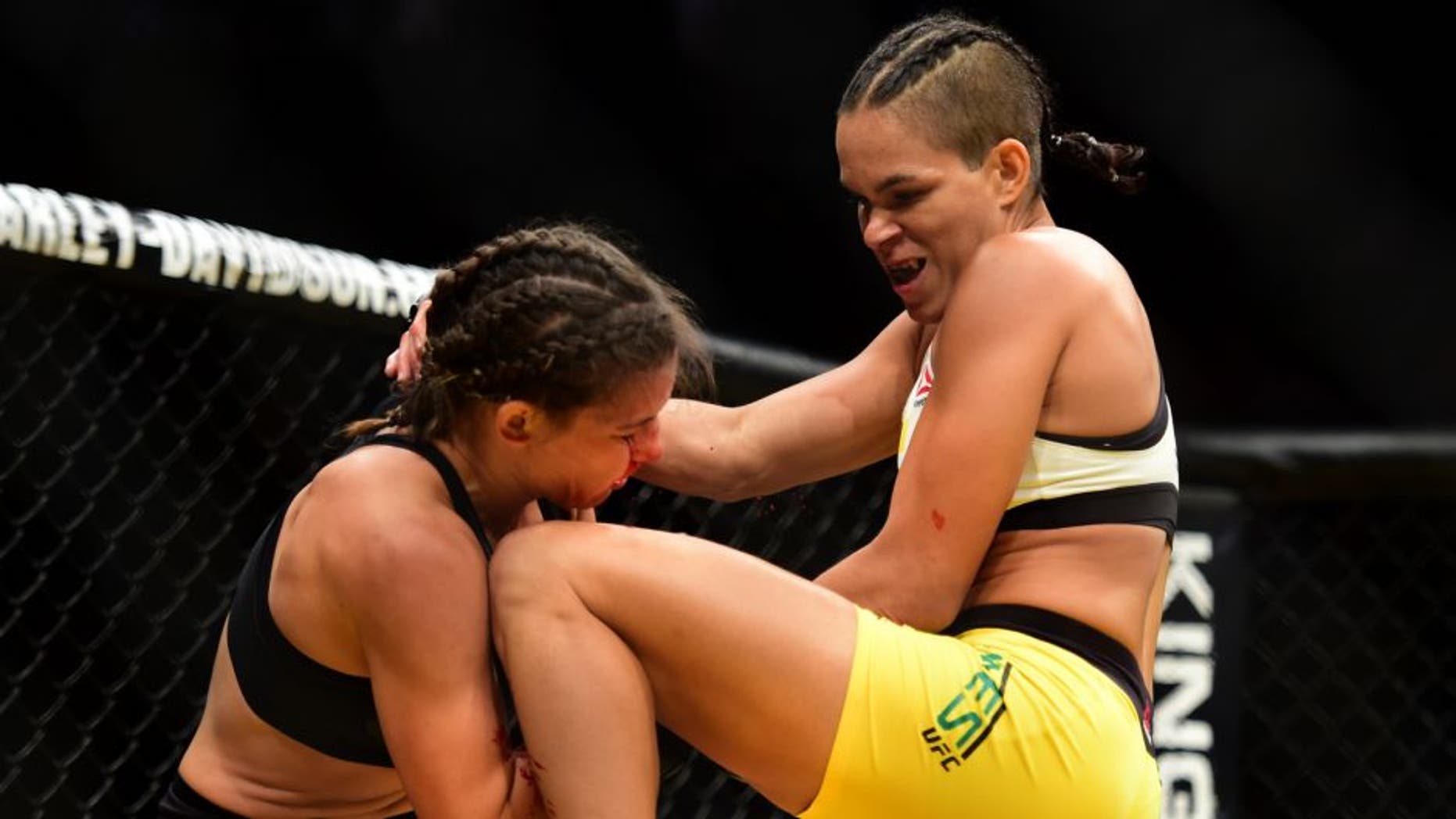 LAS VEGAS, NV - JULY 09: (R-L) Amanda Nunes of Brazil knees Miesha Tate in their UFC women's bantamweight championship bout during the UFC 200 event on July 9, 2016 at T-Mobile Arena in Las Vegas, Nevada. (Photo by Harry How/Zuffa LLC/Zuffa LLC via Getty Images)