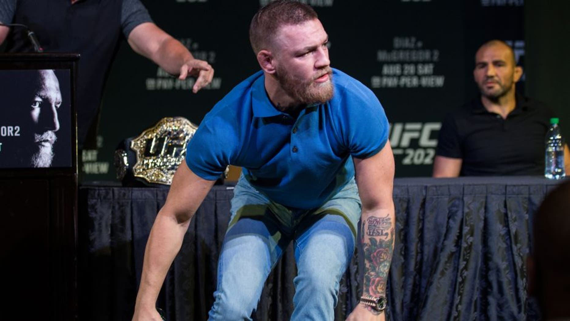 LAS VEGAS, NV - AUGUST 17: UFC featherweight champion Conor McGregor grabs two cans during the during the UFC 202 Press Conference at David Copperfield Theater in the MGM Grand Hotel/Casino on August 17, 2016 in Las Vegas, Nevada. (Photo by Brandon Magnus/Zuffa LLC/Zuffa LLC via Getty Images)
