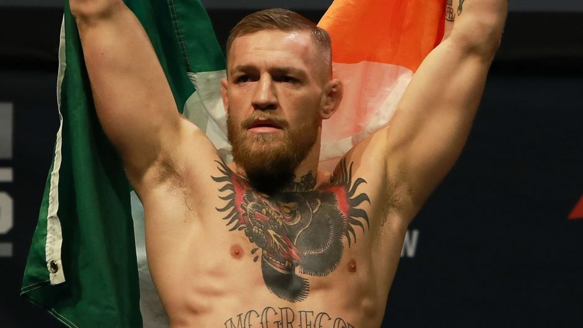 NEW YORK, NY - NOVEMBER 11: UFC Featherweight Champion Conor McGregor reacts as he walks on stage for UFC 205 Weigh-ins at Madison Square Garden on November 11, 2016 in New York City. (Photo by Michael Reaves/Getty Images)