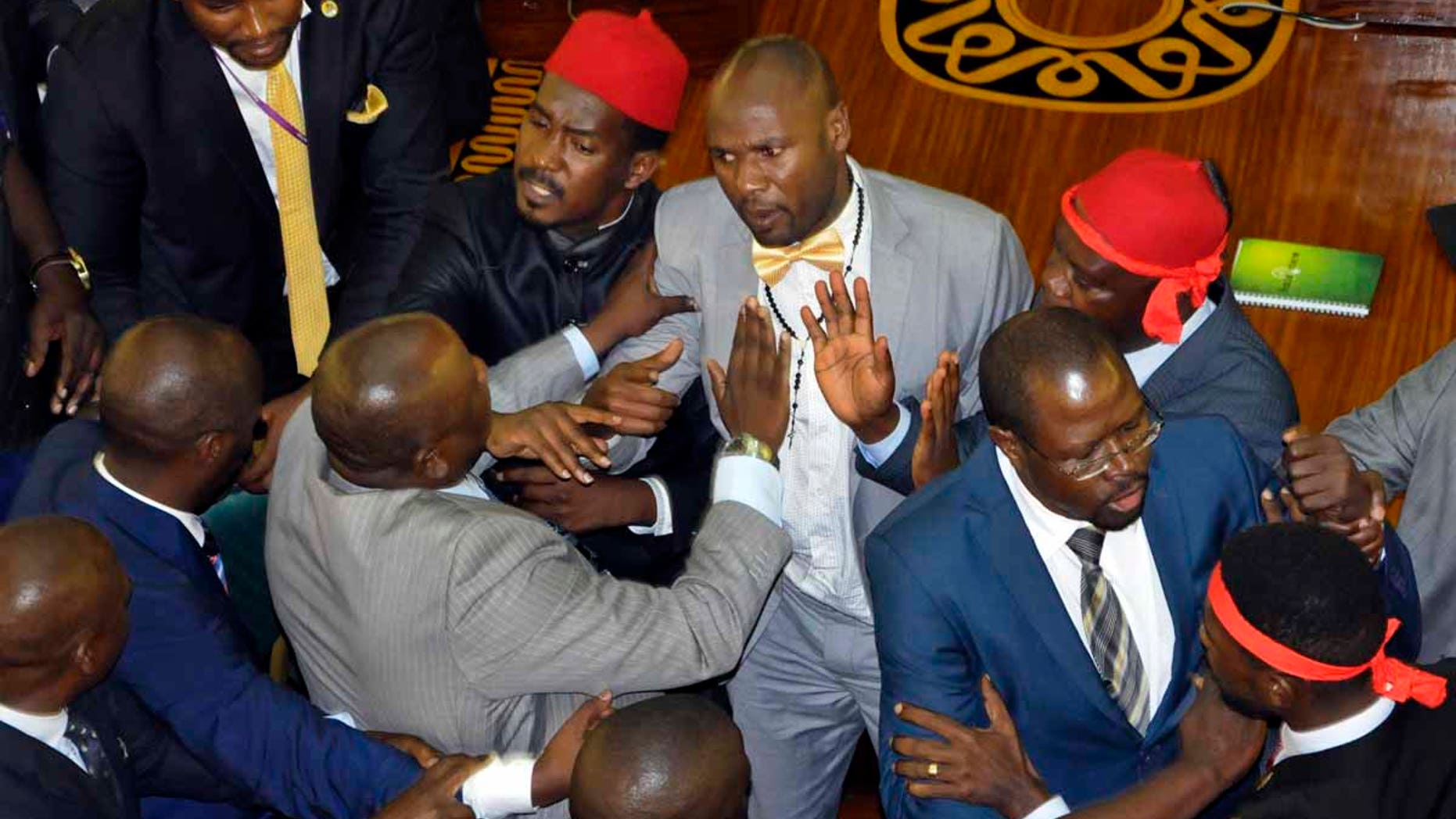 Ugandan lawmakers brawl in the Parliament in Kampala, Uganda, Tuesday, Sept. 26, 2017.
