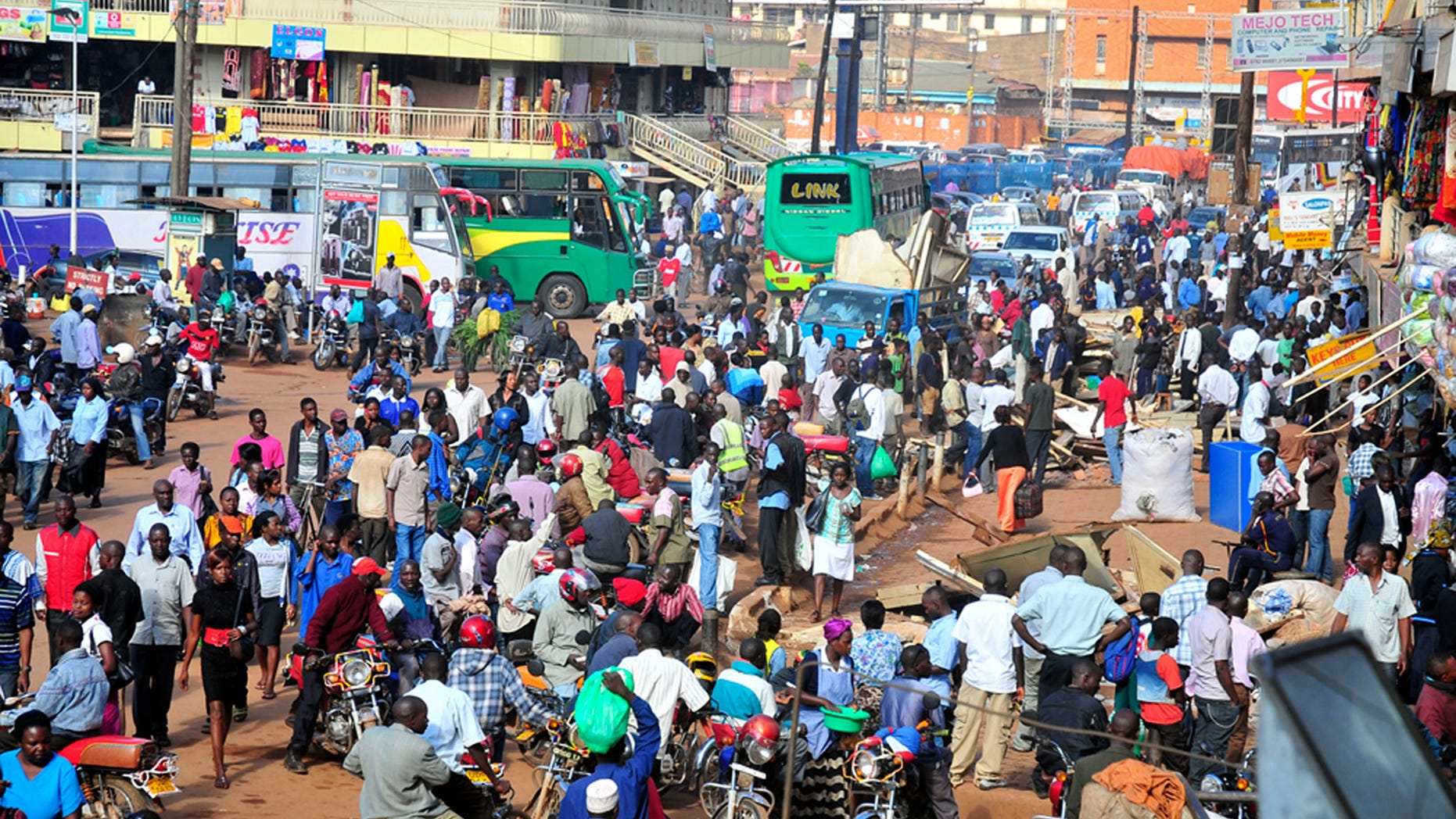 In this Saturday Oct. 1, 2011 photo, people gather at a bus terminal in Kampala, Uganda.