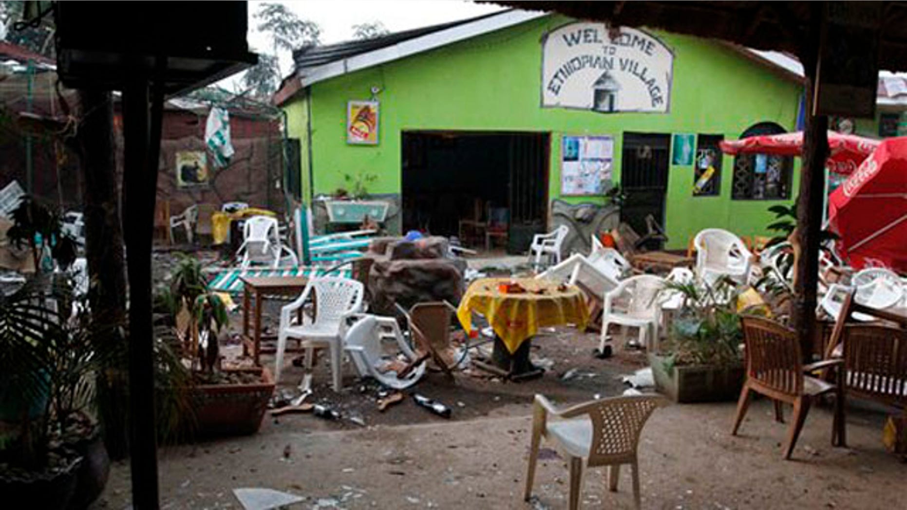 Damaged chairs and tables are seen among the debris strewn outside the restaurant "Ethiopian village" in Kampala, Uganda, July 12 after an explosion at the restaurant late Sunday. (AP Photo)