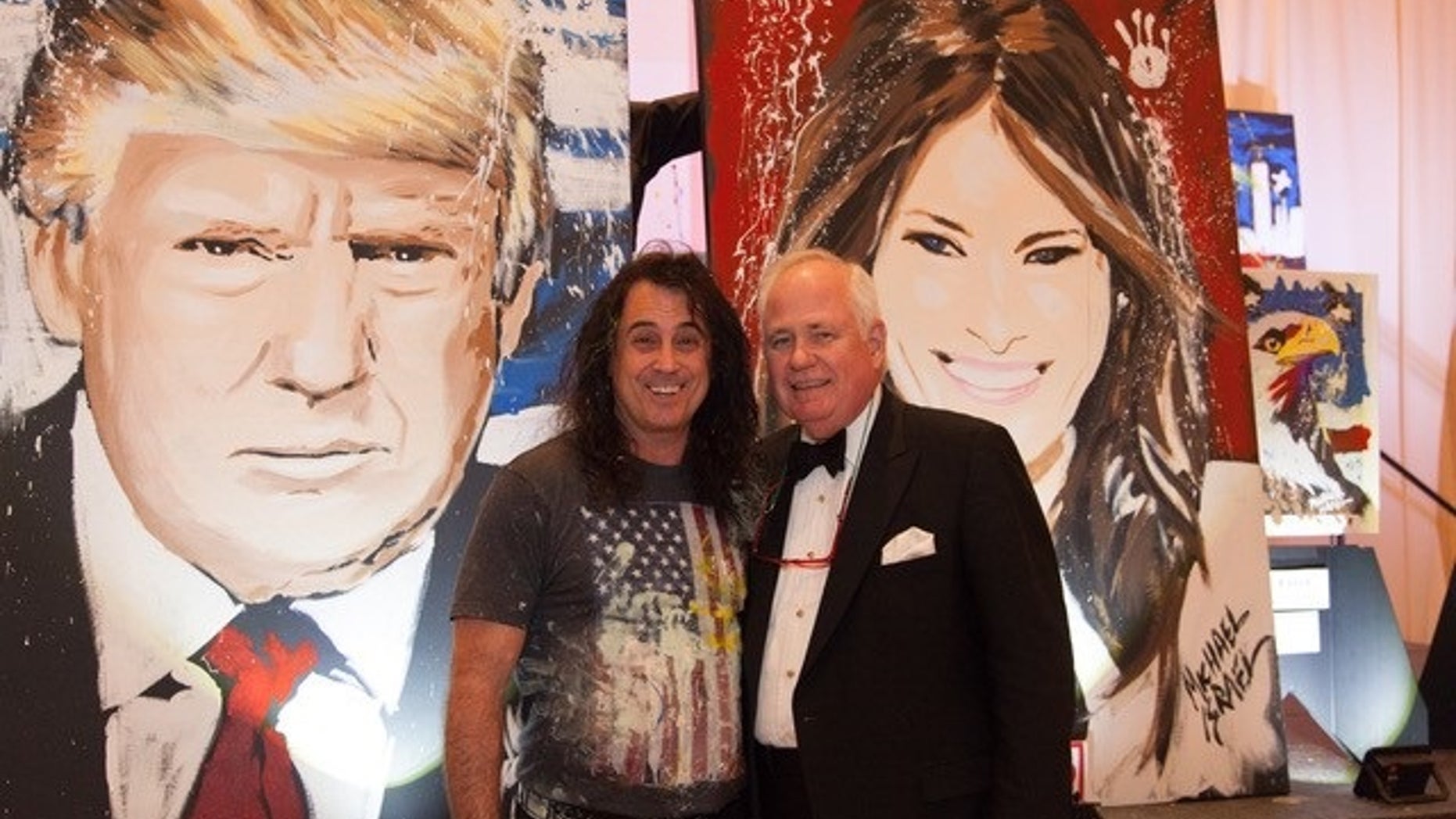 Artist Michael Israel poses with Timothy Lane, the man who bidded the highest for the paintings of President Trump and first lady Melania Trump.