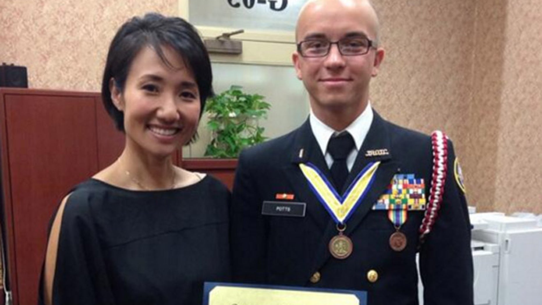 Artur Samarin, 23, was photographed with Rep. Patty Kim after he was inducted into the National Honor Society