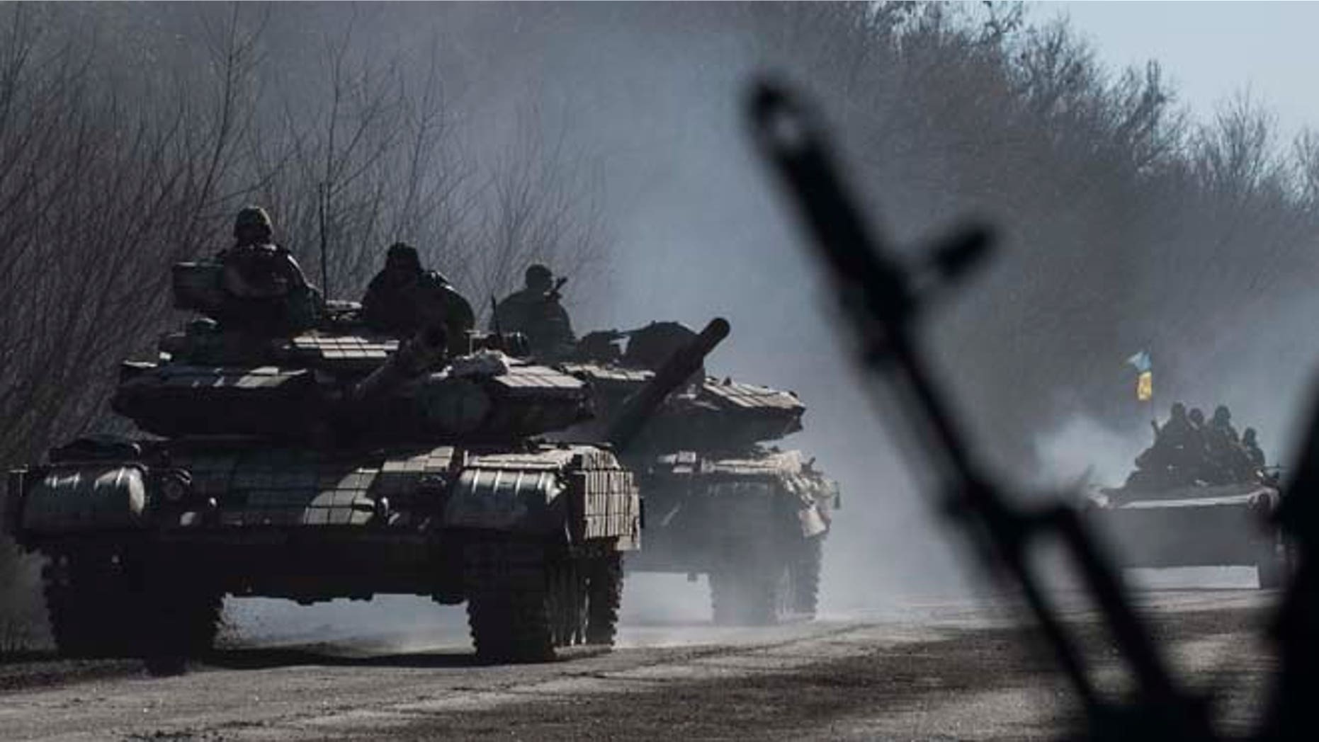 Feb. 24, 2015: Ukrainian troops ride on tanks near Artemivsk, eastern Ukraine. Ukrainian officials said they havent yet started pulling heavy weapons back from a frontline in eastern Ukraine because of continued rebel violations of a cease-fire deal.