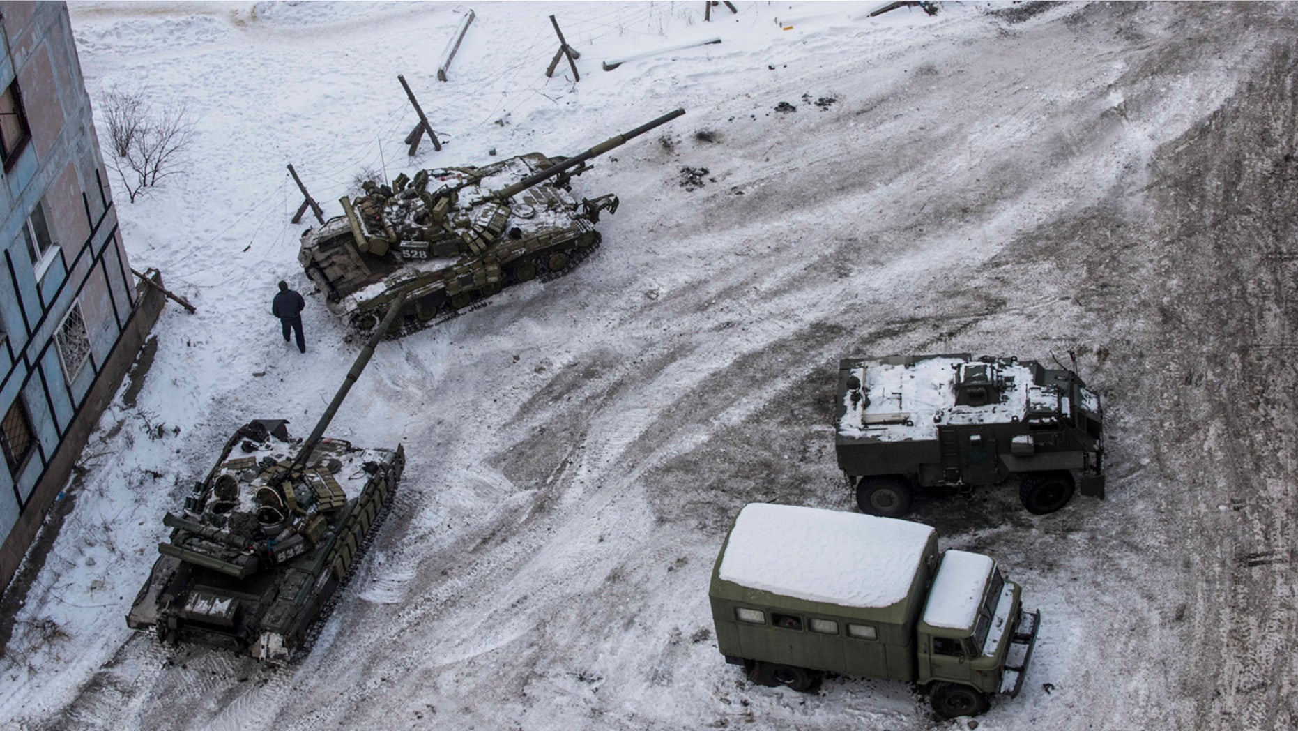 Ukrainian tanks stand in the yard of an apartment block in Avdiivka, eastern Ukraine, Wednesday, Feb. 1, 2017.