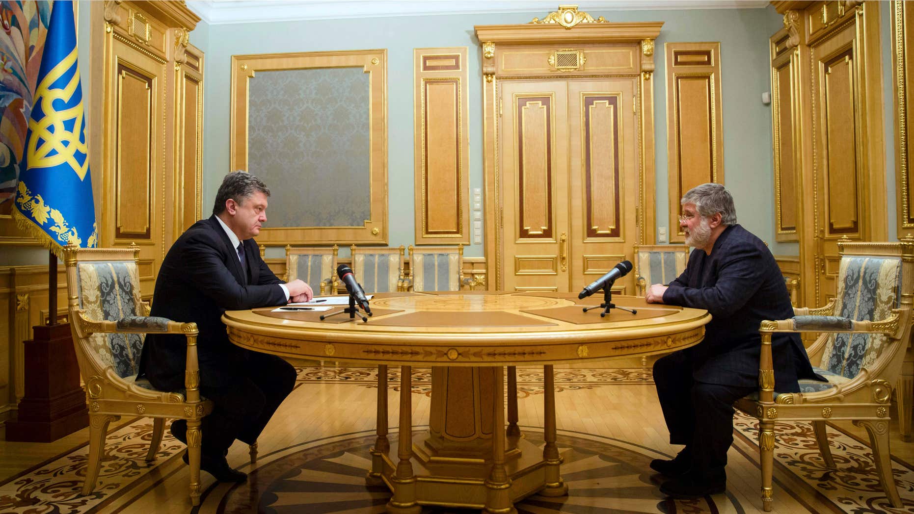 March 25, 2015: Ukraine's President Petro Poroshenko, left, listens to Ihor Kolomoysky, governor of Dnipropetrovsk, in Kiev, Ukraine.