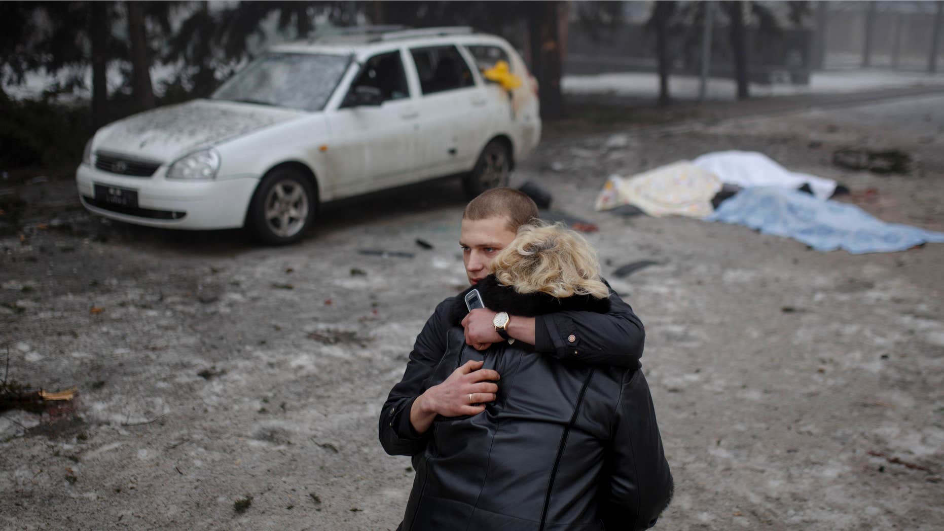 Jan. 30, 2015: A rebel comforts a wife of a killed civilian in shelling in Donetsk, eastern Ukraine.