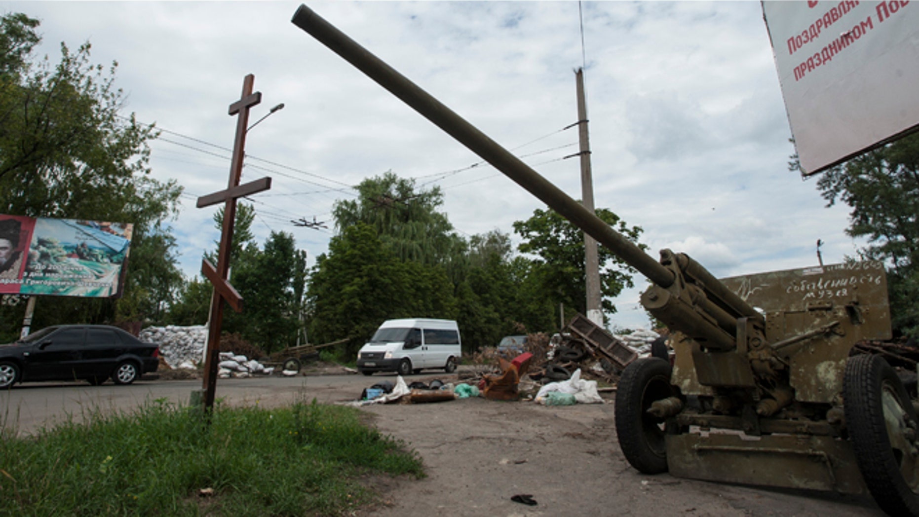 July 9, 2014: Cars pass an empty pro-Russian checkpoint after heavy fighting between pro-Russian fighters and Ukrainian government troops outside Slovyansk, eastern Ukraine. The rebels fled Slovyansk, a city of 100,000 that had been their stronghold, over the weekend as Ukrainian troops mounted an offensive. They left behind a city heavily damaged by fighting and riven by vehemently differing views.
