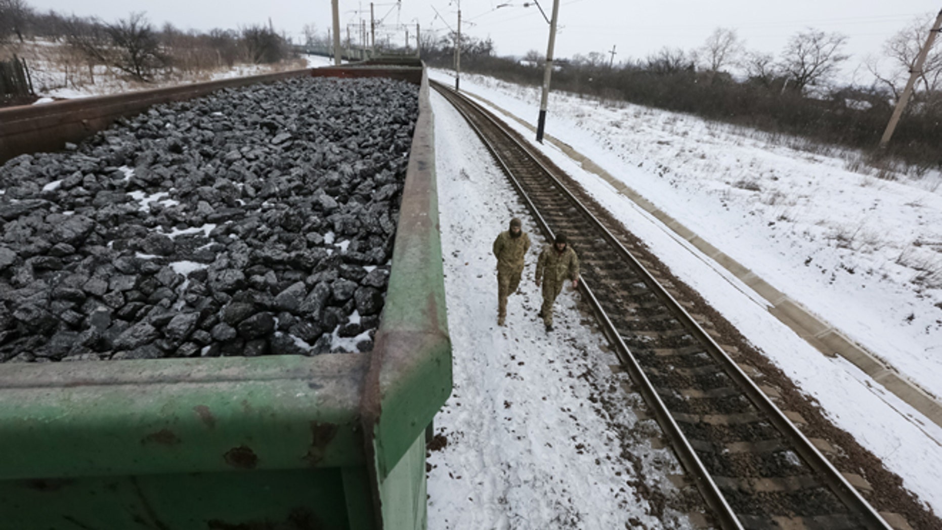 Activists walk along carriages loaded with coal from the occupied territories which they blocked at Kryvyi Torets station in the village of Shcherbivka in Donetsk region, Ukraine, February 14, 2017.