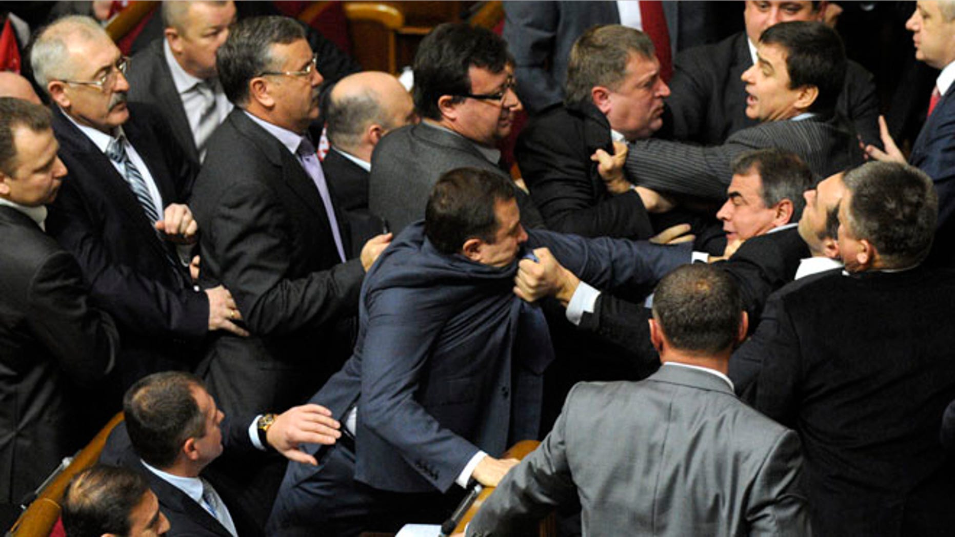Dec. 13, 2012: Ukrainian lawmakers fight around the rostrum during the first session of Ukraine's newly elected parliament in Kiev, Ukraine.