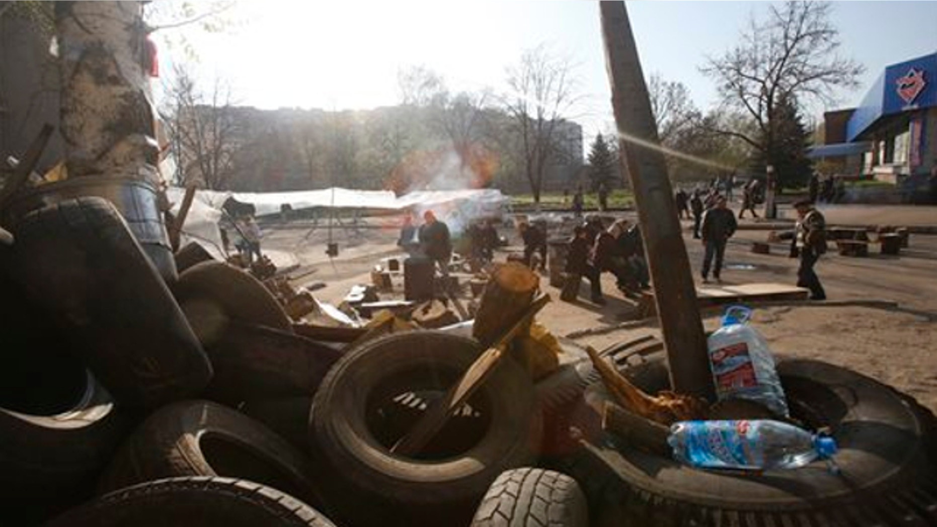 April 16, 2014: People gather in front of a barricade across a street in Slovyansk, eastern Ukraine. The city of Slovyansk has come under the increasing control of the pro-Russian gunmen who seized it last weekend.