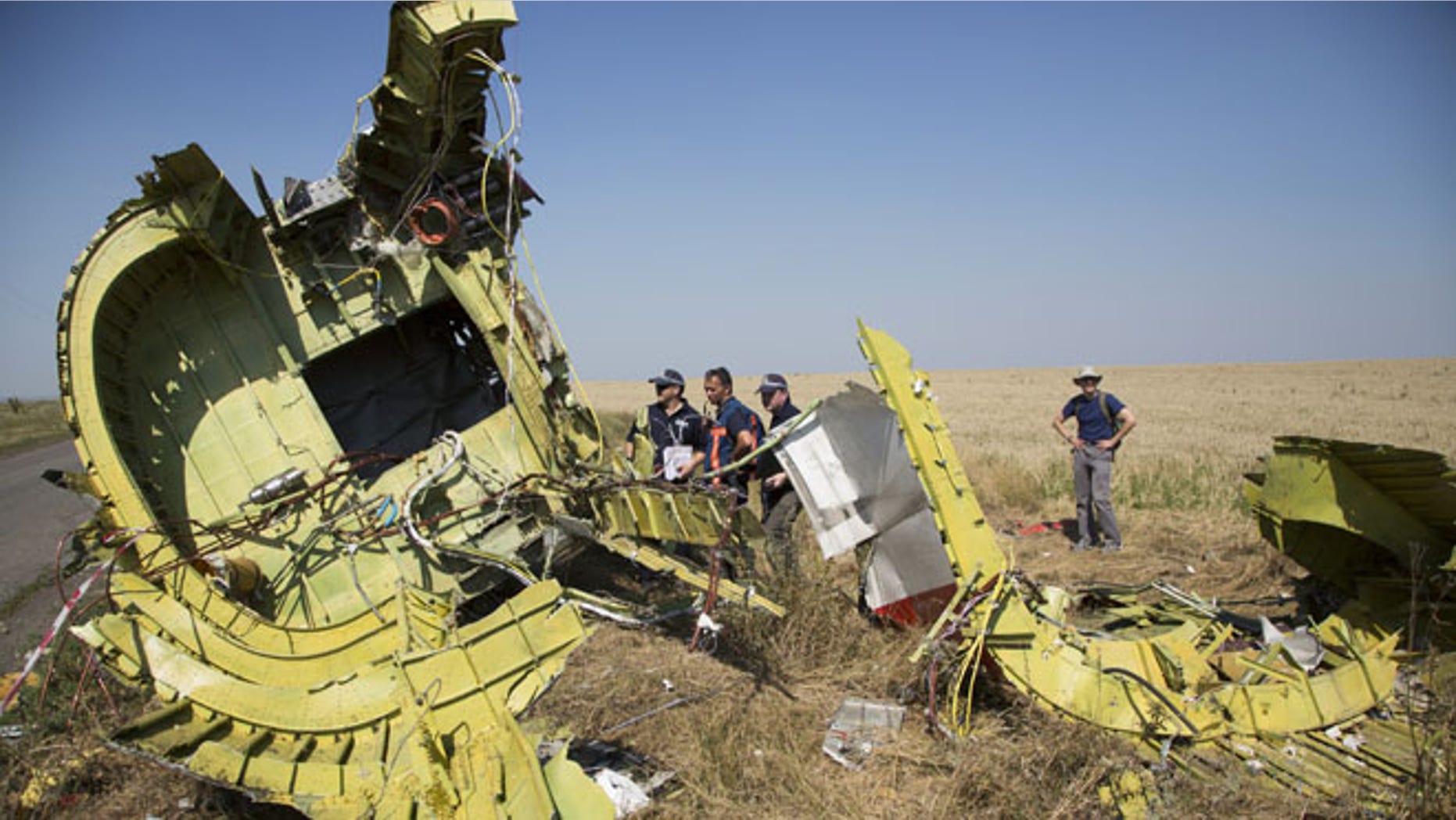 Aug 1, 2014: Australian and Dutch investigators examine pieces of the Malaysia Airlines Flight 17 plane, near the village of Hrabove, Donetsk region, eastern Ukraine.
