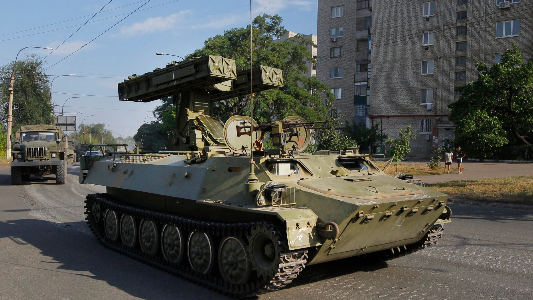 FILE - In this is Sunday, Aug. 17, 2014 file photo, a pro-Russian missile launcher drives in the town of Krasnodon. (AP Photo/Sergei Grits, File)