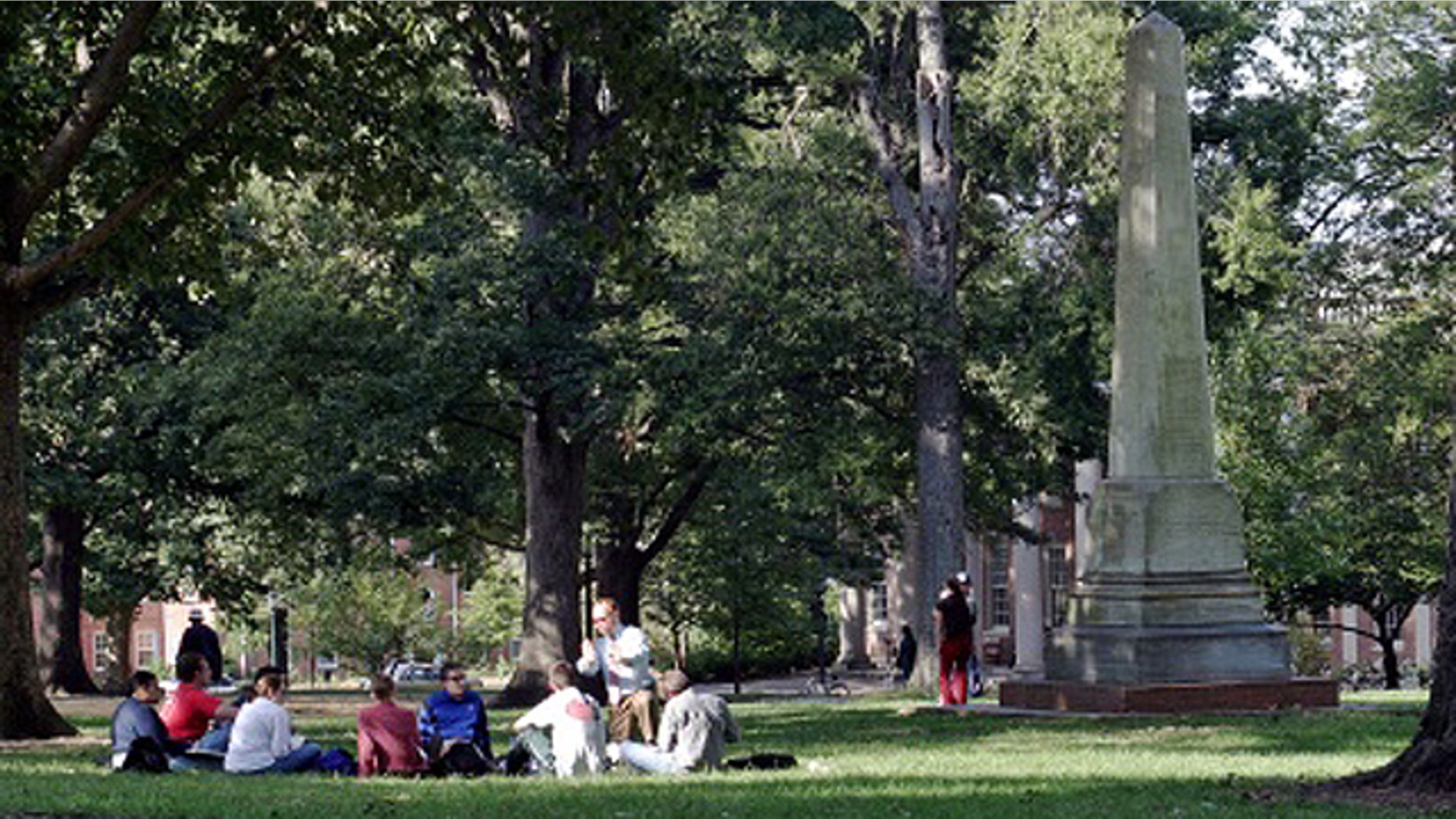 University of North Carolina at Chapel Hill students congregate near a landmark dedicated to Joseph Caldwell, the first president of the university. Anti-abortion activists aren't satisfied with giving students the option to include or drop a clause in their university-sponsored health insurance plan that provides coverage for elective abortions.