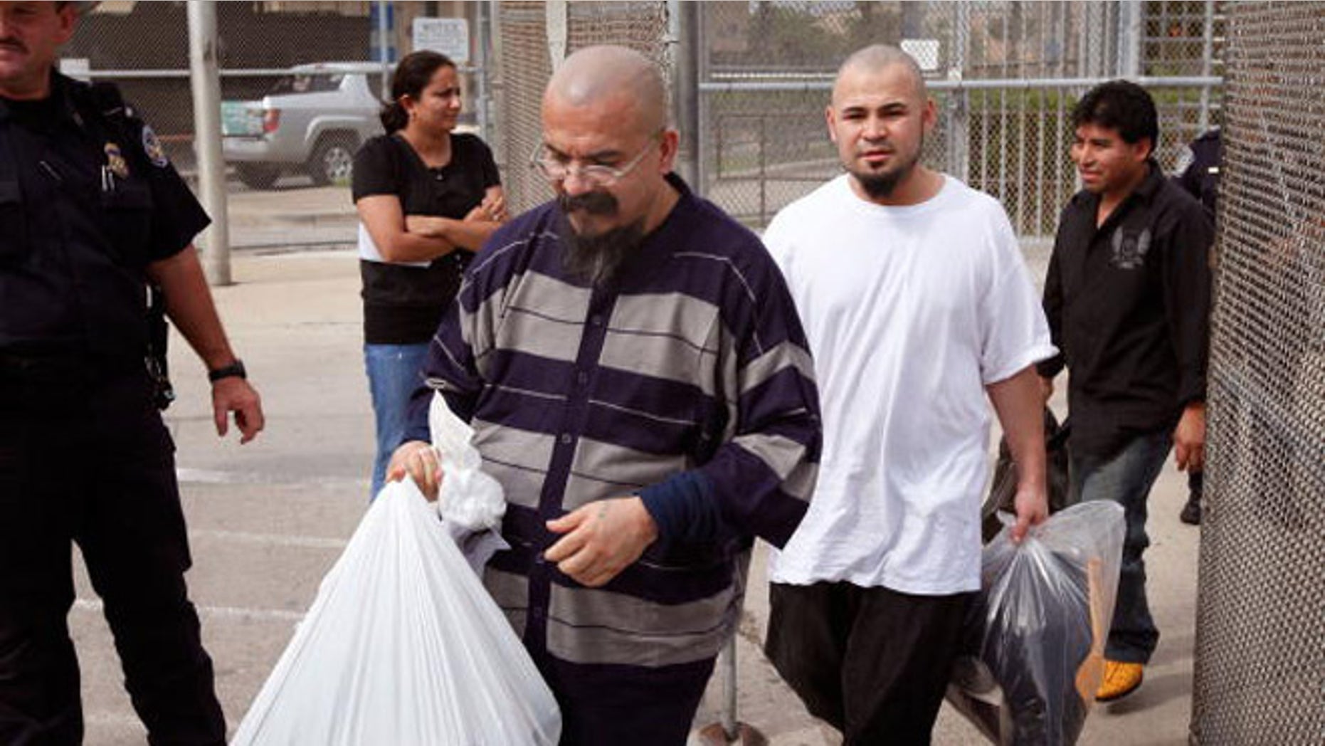BROWNSVILLE, TX - MAY 25: Undocumented Immigrants are led through the gate at a border control station after being deported by U.S. Immigration and Customs Enforcement (ICE) agents May 25, 2010 in Brownsville. The immigrants started the morning at an ICE processing center in suburban Chicago before boarding a charter flight to Harlingen, Texas where they were then bussed to Brownsville and finally walked to the Mexican border and released from custody. The U.S. deports over 350,000 immigrants a year for entering the country illegally, most are Mexican, and more than 90 percent are men. (Photo by Scott Olson/Getty Images)