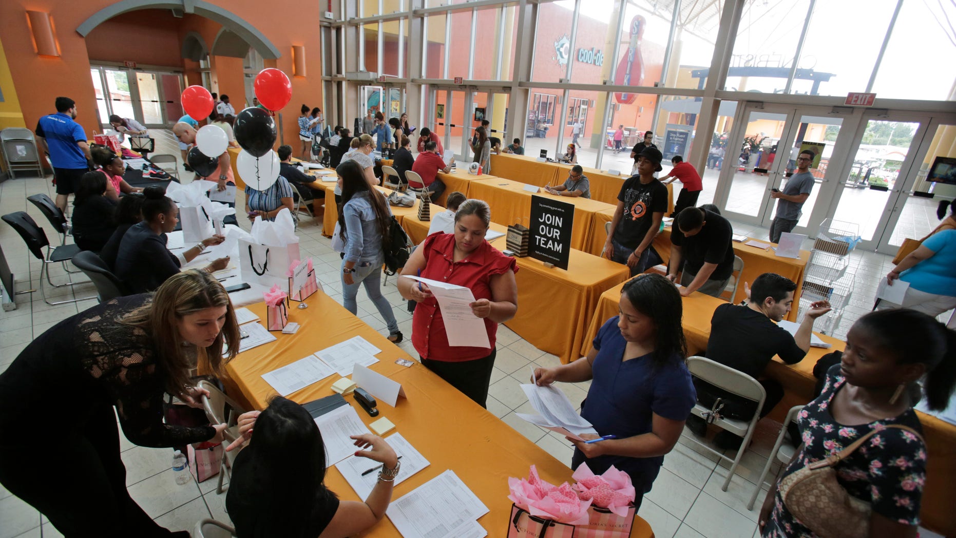 Oct. 6, 2015 -Job applicants fill out forms at a job fair in Miami. (AP)