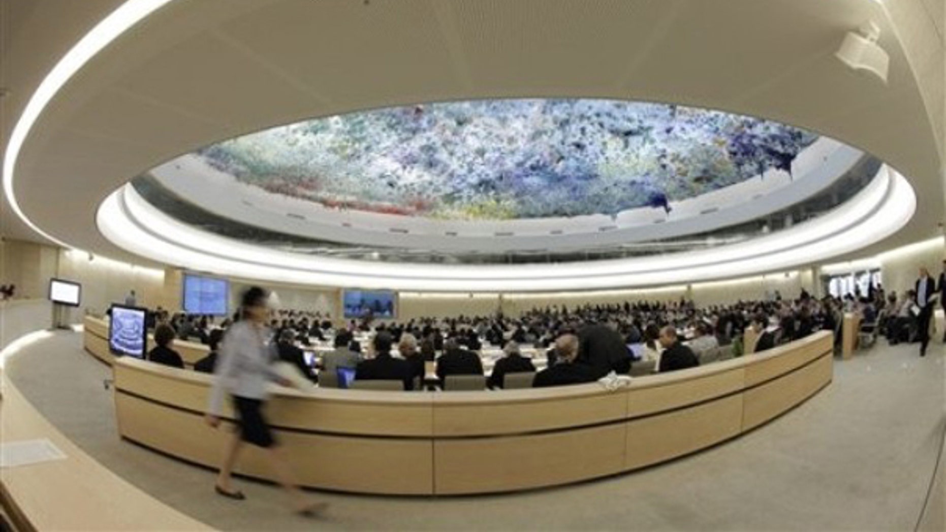 A woman walks past the Human Rights Council at the European headquarters of the United Nations in Geneva May 31. (AP Photo)