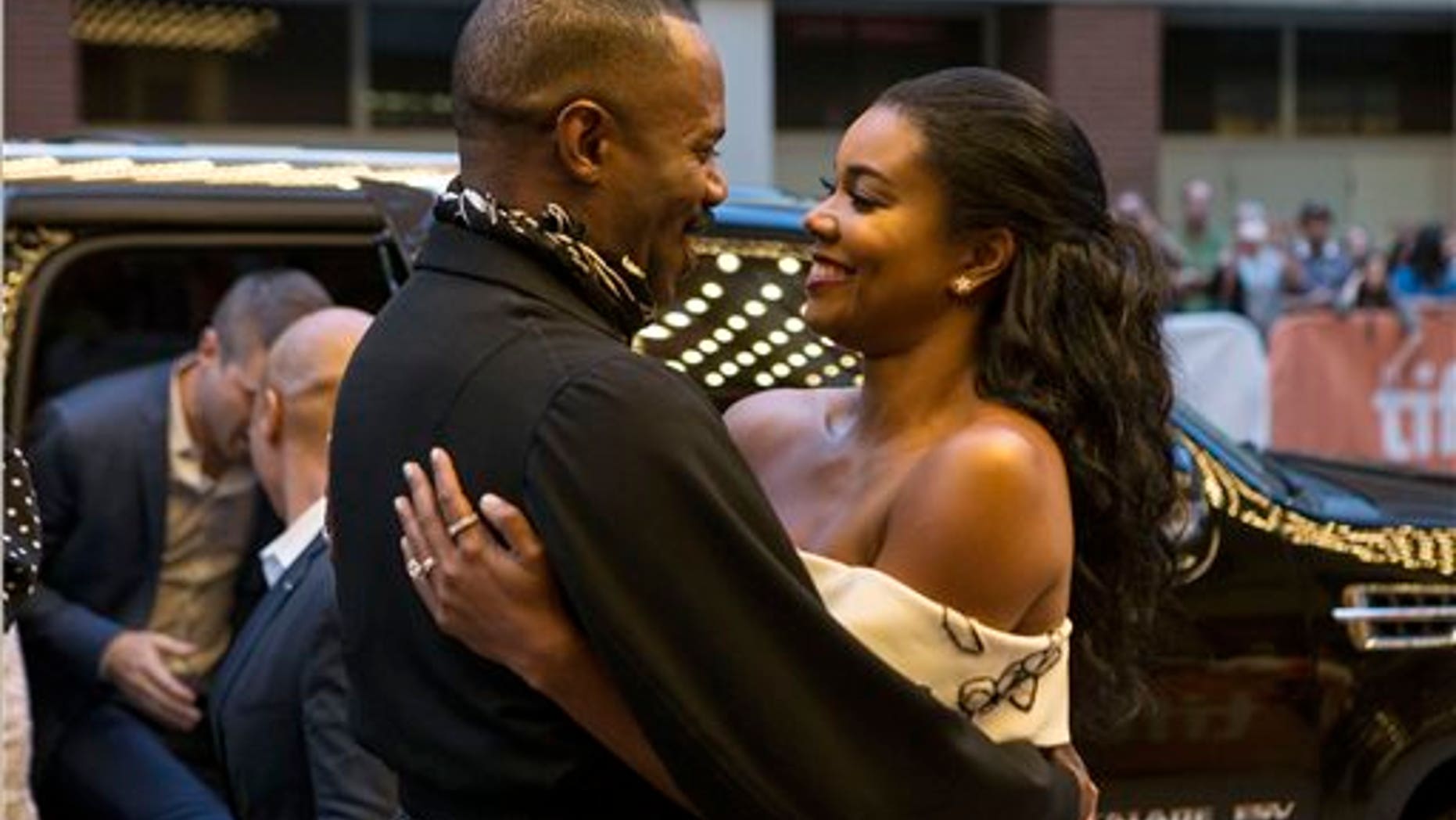 Colman Domingo, left, embraces fellow actor Gabrielle Union as they arrive on the red carpet for the film "Birth of a Nation" during the 2016 Toronto International Film Festival in Toronto on Sept. 9, 2016. (Chris Young/The Canadian Press via AP)