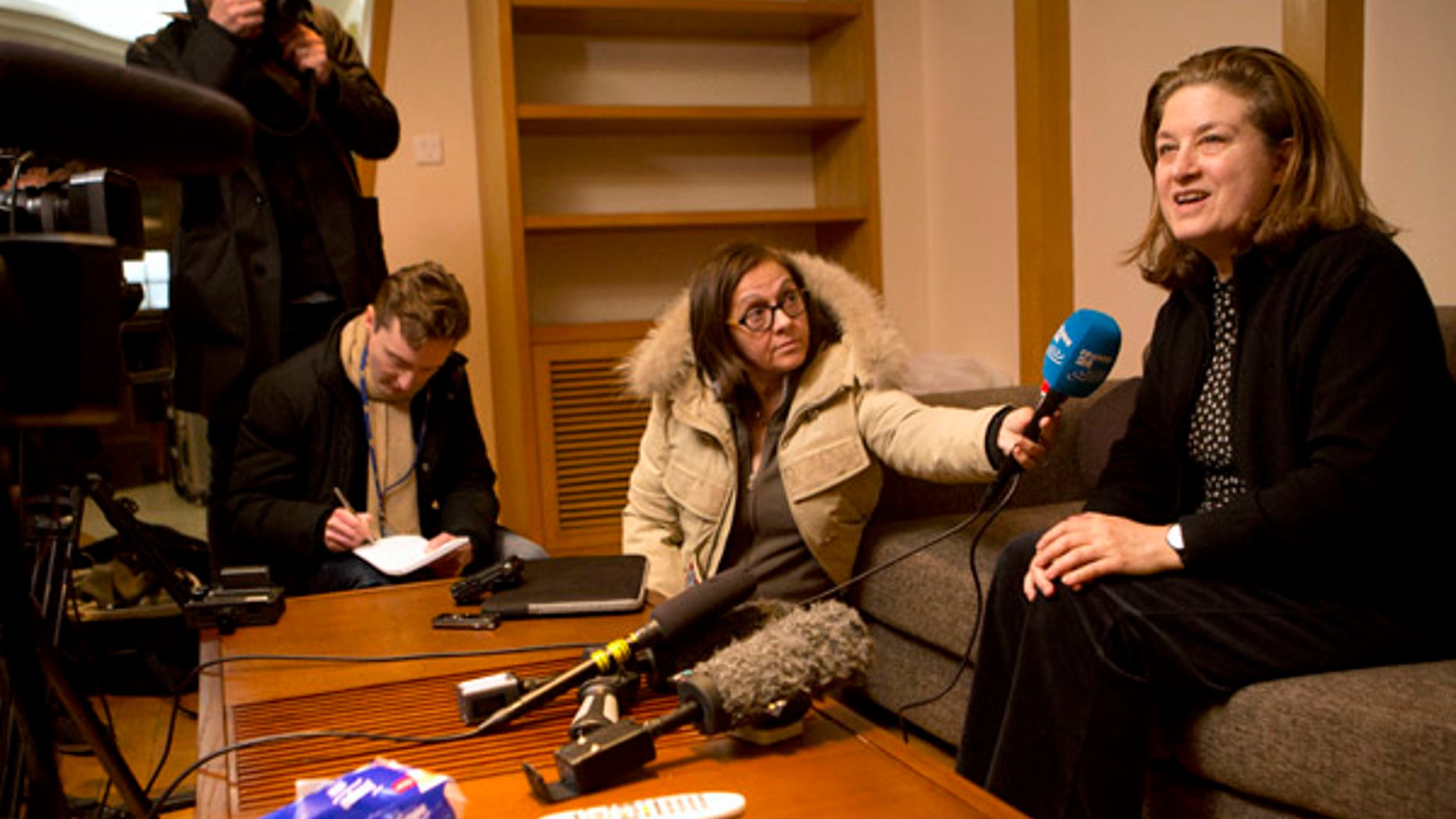 Dec. 31, 2015: French journalist Ursula Gauthier, right, a reporter in China for the French news magazine L'Obs, speaks to the media in her apartment before leaving for the airport in Beijing (AP)