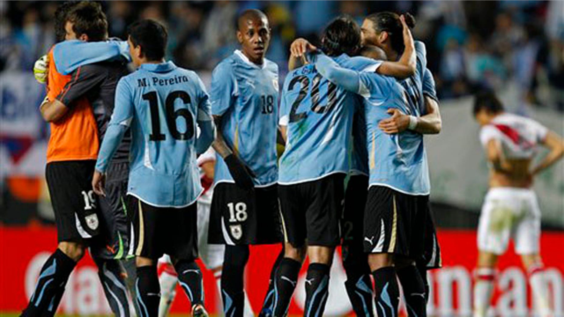 Uruguay's players celebrate at the end of a Copa America semifinal soccer match with Peru in La Plata, Argentina, Tuesday, July 19, 2011. Uruguay won the match 2-0 and advanced to the final. (AP Photo/Ricardo Mazalan)