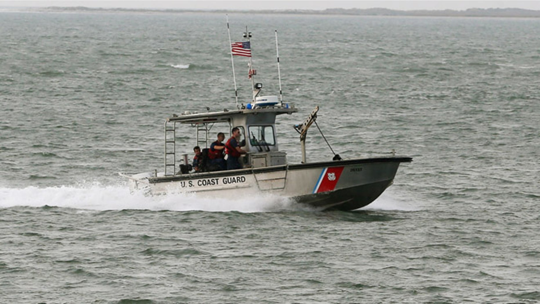 ATLANTIC, VA - OCTOBER 29: A U.S. Coast Guard boat patrols the waters near NASA's Wallops Flight Facility, October 29, 2014 in Atlantic, Virginia. An unmanned Orbital Sciences Corporation Antares commercial rocket headed for the International Space Station to deliver supplies exploded into a massive fireball in the early evening of October 28, seconds after lifting off from the launch pad at NASA's Wallops Island Flight Facility. (Photo by Mark Wilson/Getty Images)