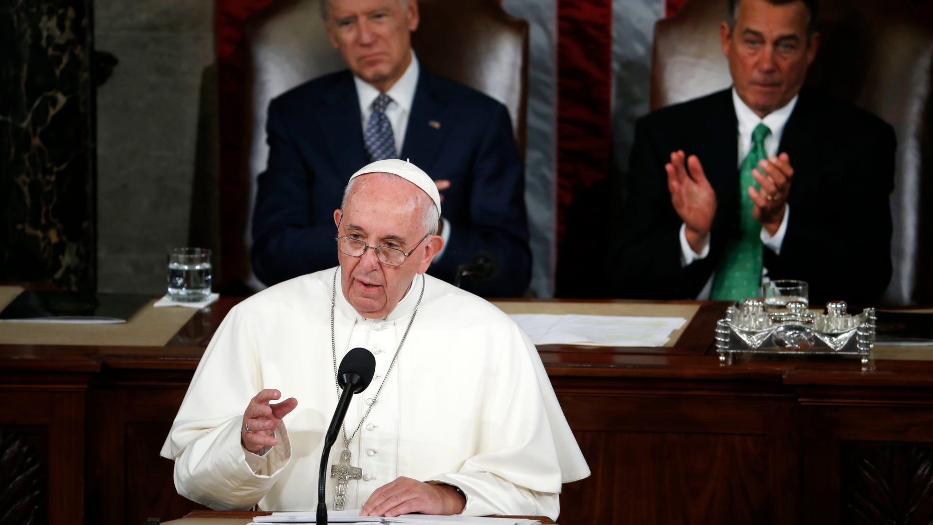 Pope Francis addresses a joint meeting of Congress on Capitol Hill in Washington, Thursday, Sept. 24, 2015, making history as the first pontiff to do so. Listening behind the pope are Vice President Joe Biden and House Speaker John Boehner of Ohio. (AP Photo/Carolyn Kaster)