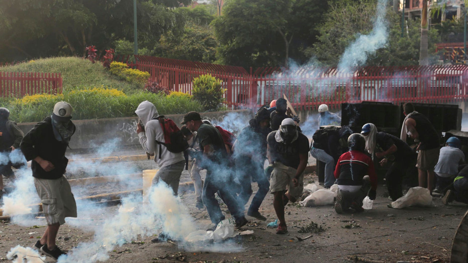 Demonstrators clash with the Bolivarian National Guard, at El Hatillo municipality outside Caracas, Venezuela, Tuesday, May 2, 2017.