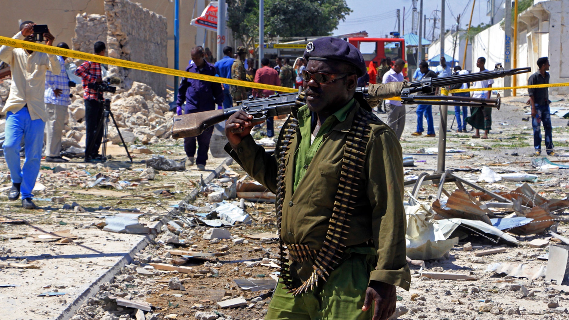 FILE - In this Jan. 2, 2017, file photo, a Somali soldier patrols the area of a suicide car bomb attack in Mogadishu, Somalia.