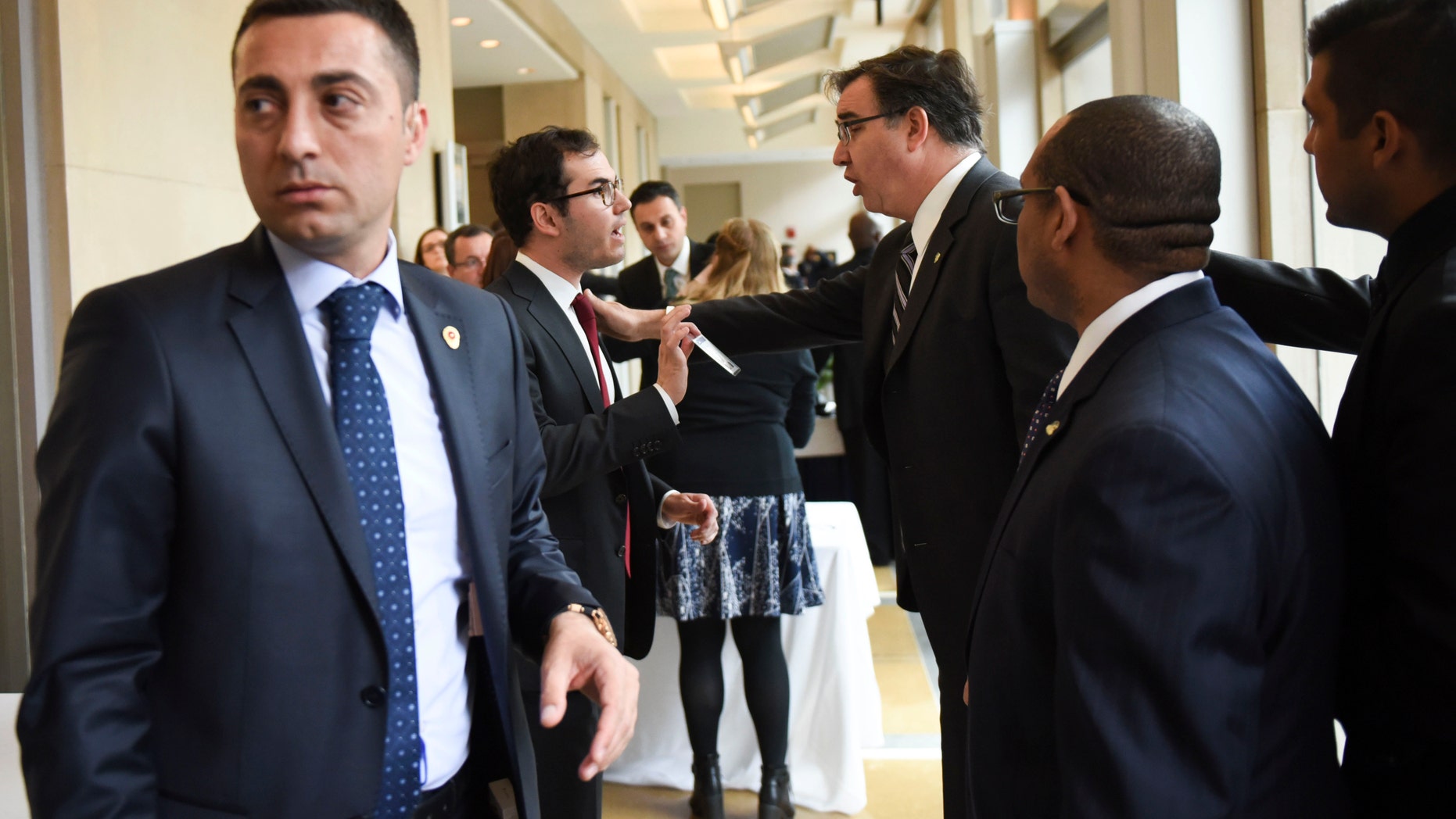 Brookings Institute Vice President and Chief Operating Officer Steve Bennett, center right, before Turkish President Recep Tayyip Erdogan speaks.