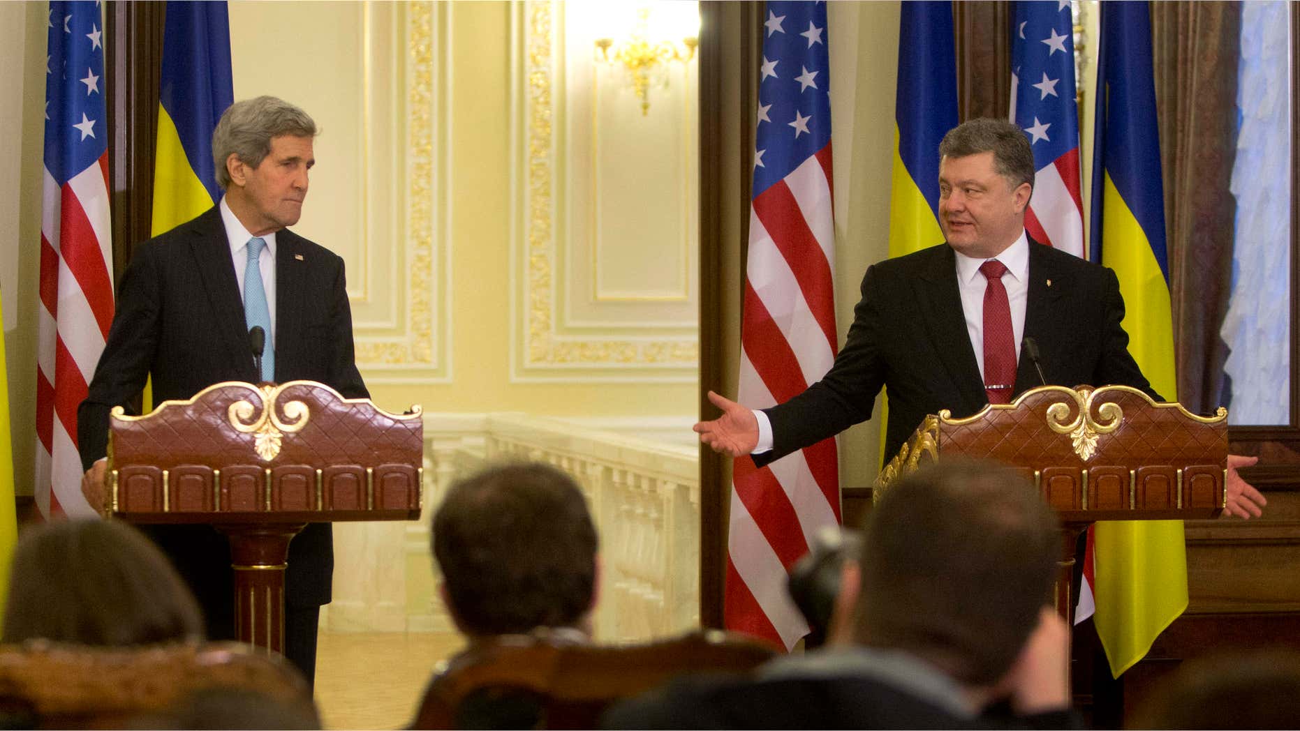 Feb. 5, 2015: Ukrainian President Petro Poroshenko, right, gestures toward U.S. Secretary of State John Kerry during their statement to the media at the Presidential Administration Building in Kiev, Ukraine.