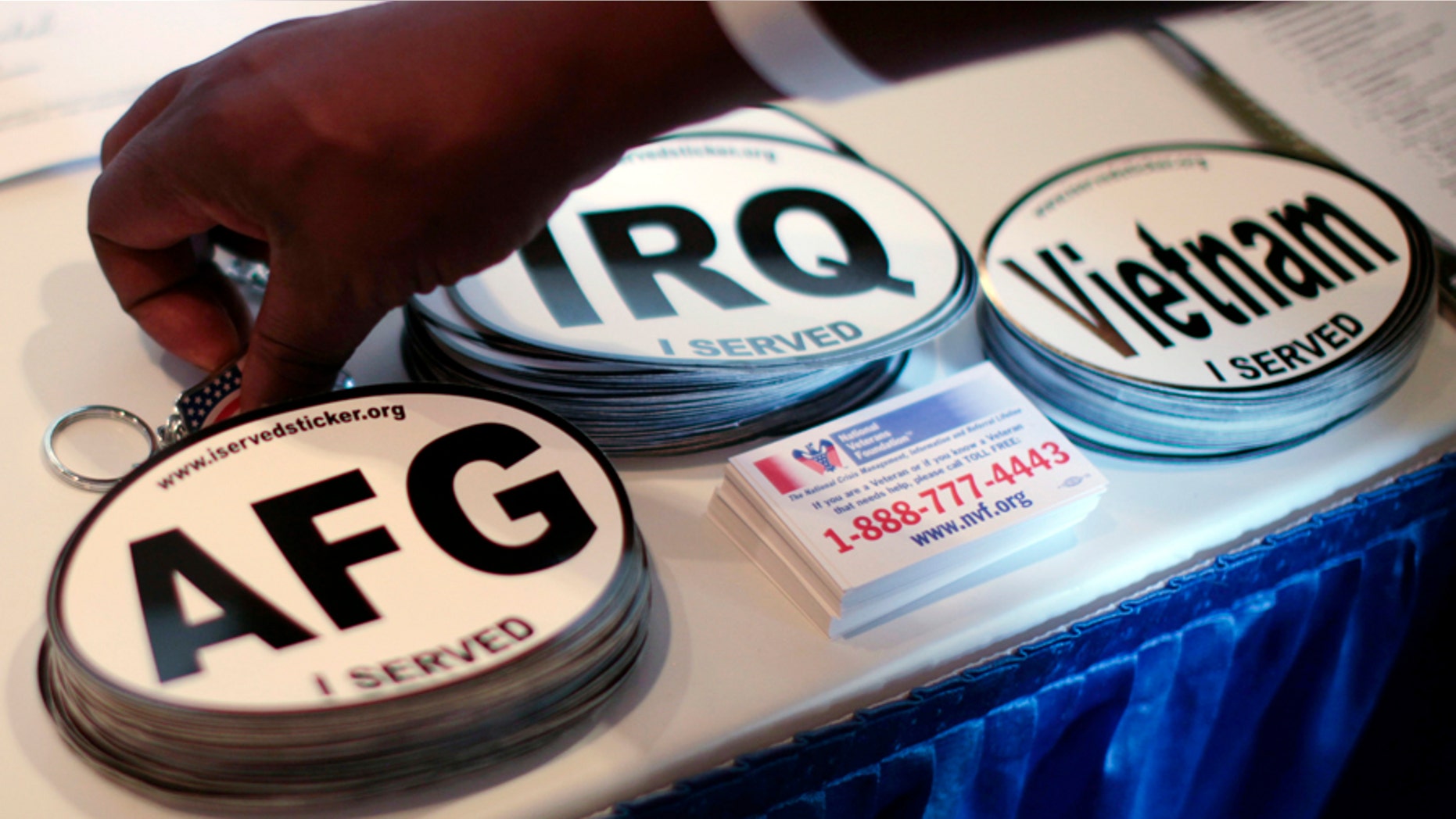 Car stickers commemorating U.S. military service in Vietnam, Afghanistan and Iraq are seen on a recruiter's table at a veterans job fair in Los Angeles, California November 10, 2010. REUTERS/Lucy Nicholson (UNITED STATES - Tags: EMPLOYMENT BUSINESS) - GM1E6BB0KP901