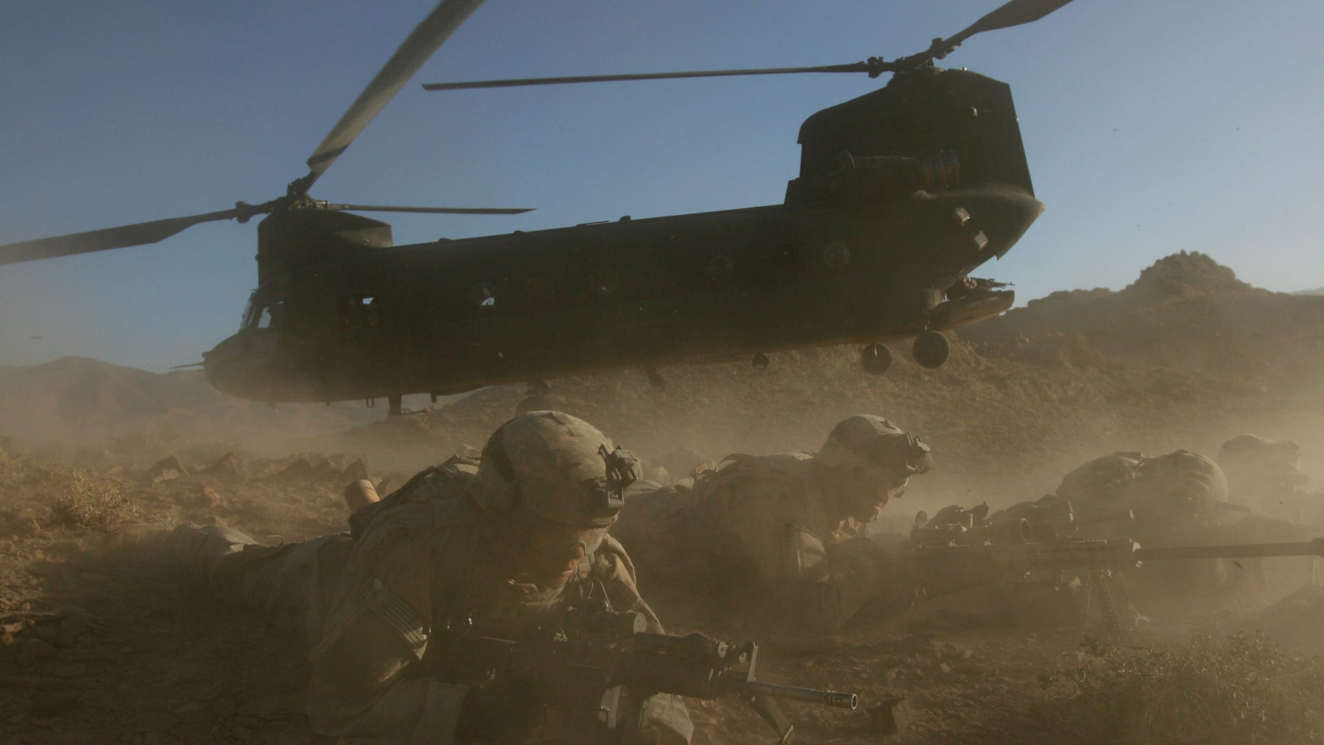 U.S. soldiers from the 2nd Brigade, 87th Infantry Regiment, 10th Mountain Division, secure the area after existing a Chinoonk helicopter, Helmand Province, southern Afghanistan, in this Sunday, June 18, 2006 file photo. Insurgents apparently shot down a U.S. military helicopter Saturday Aug. 6, 2011 similar to this one shown during fighting in eastern Afghanistan, killing 30 Americans, most of them belonging to the same elite Navy SEALs unit that killed Usama bin Laden, as well as seven Afghan commandos, U.S. officials said.
