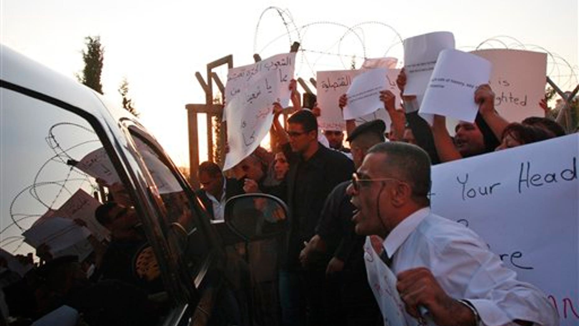 Oct. 4: Palestinians yell at a U.S. diplomatic vehicle during protest against U.S. in the West Bank city of Ramallah. Angry Palestinians accosted a top American official Tuesday during a celebratory West Bank visit in honor of Palestinians who graduated from American-funded education programs.