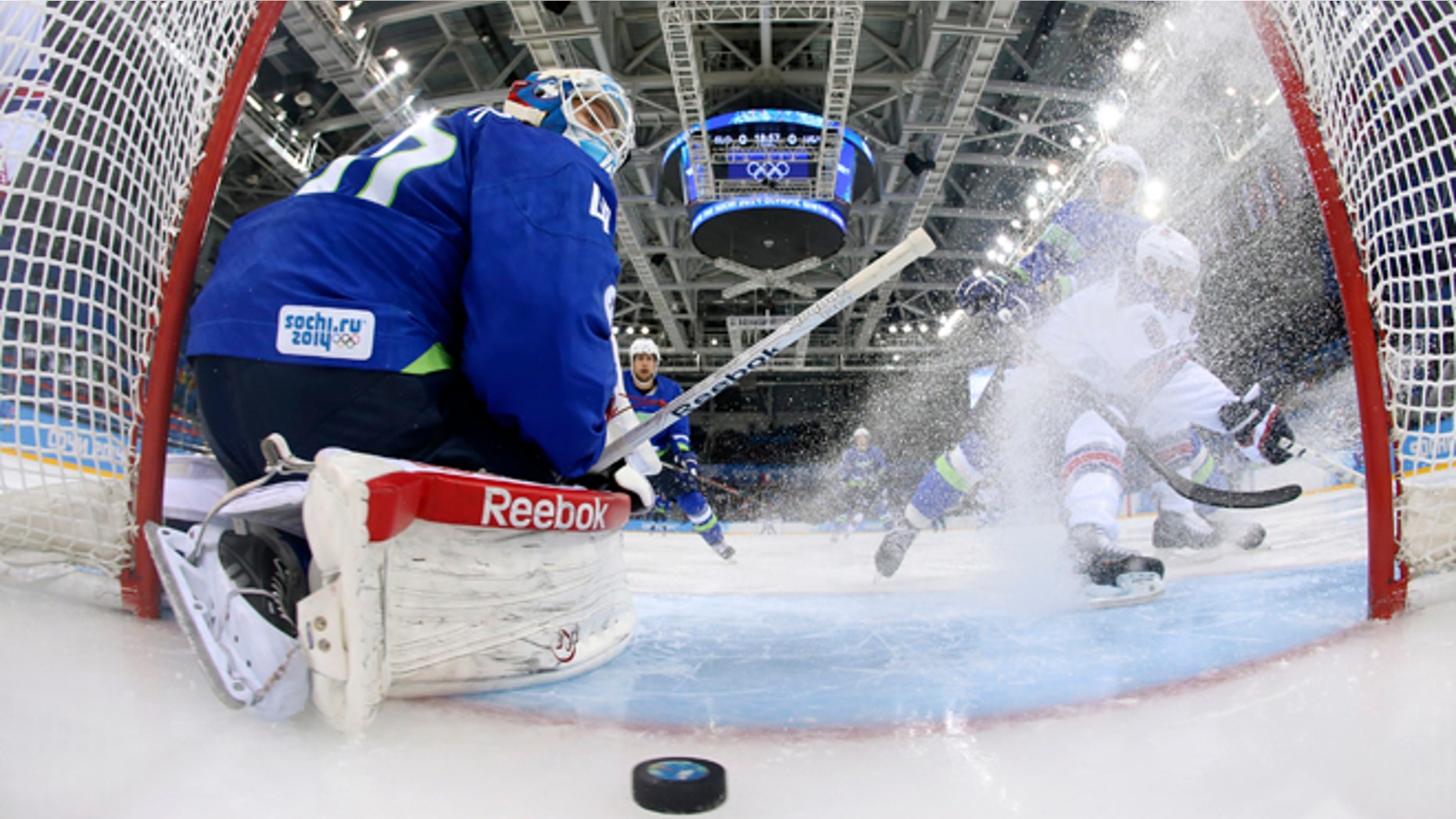 Feb. 16, 2014: Slovenia goaltender Luka Gracnar looks back at the puck after USA forward Phil Kessel scored period of a men's ice hockey game at the 2014 Winter Olympics, Sunday, Feb. 16, 2014, in Sochi, Russia.