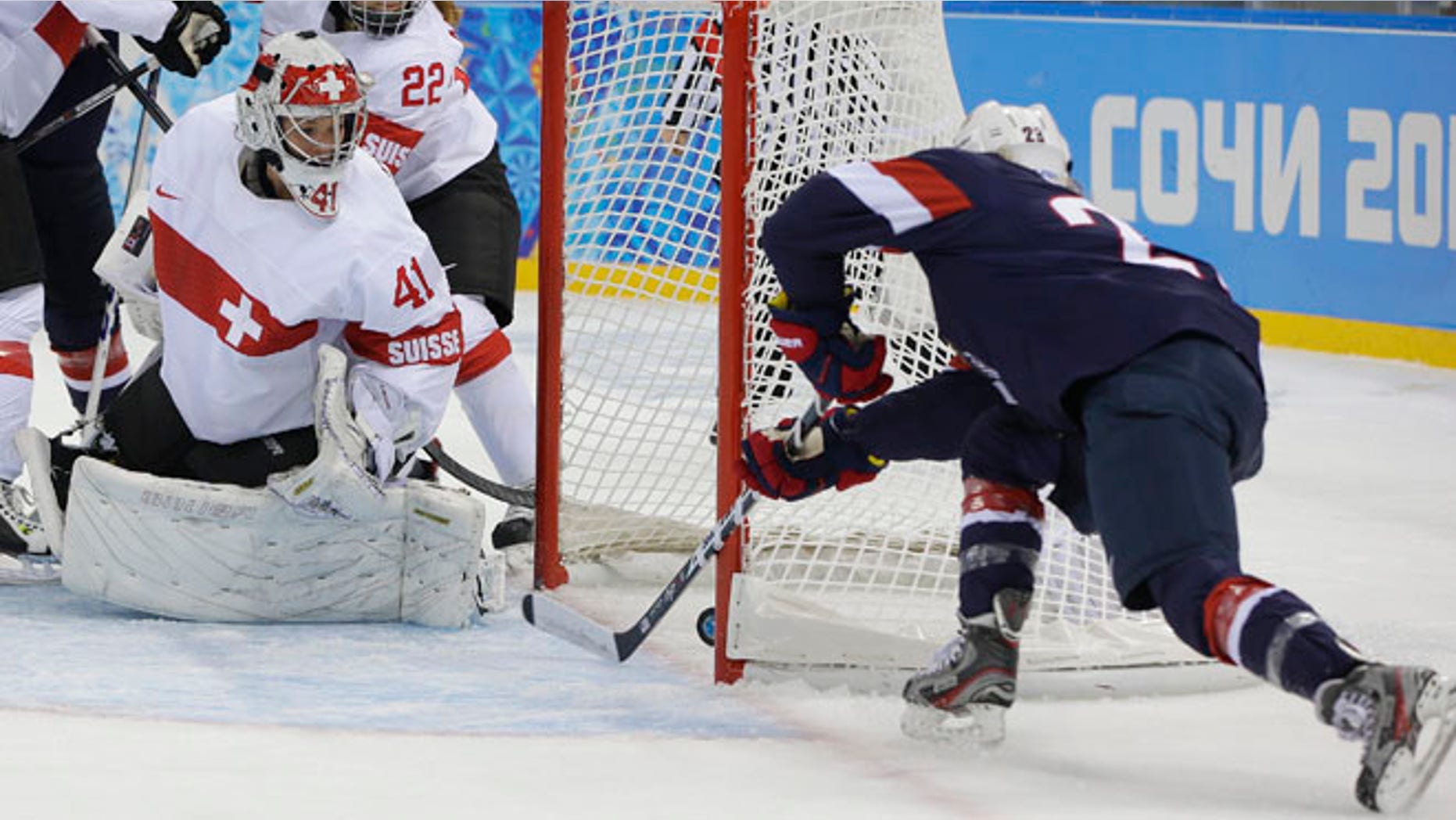 Feb. 10, 2014: Goalkeeper Florence Schelling of Switzerland watches as Amanda Kessel of the Untied States shoot slides in for the goal during the first period of the 2014 Winter Olympics women's ice hockey game at Shayba Arena in Sochi, Russia.