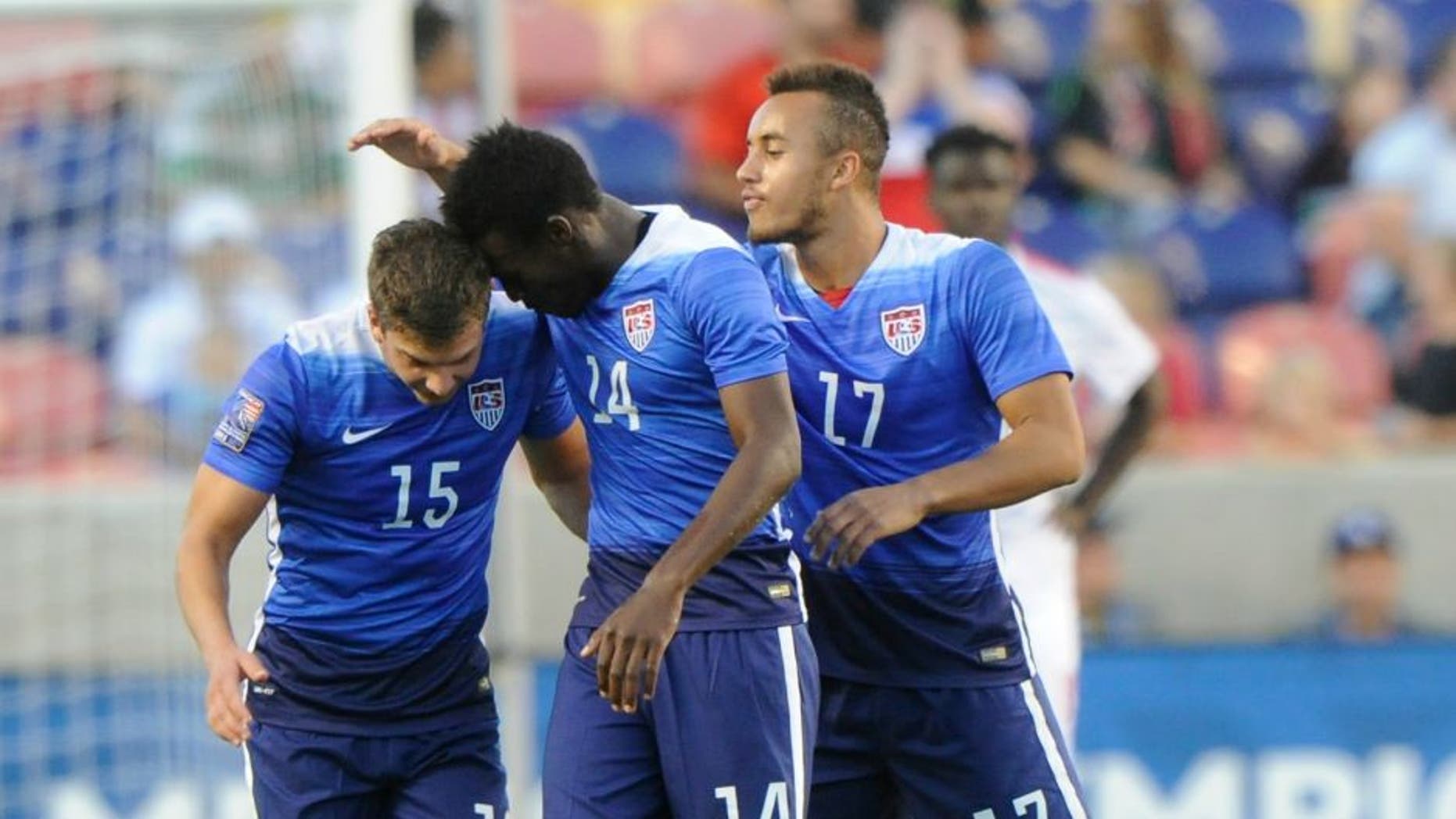 SANDY UT- OCTOBER 13: Marc Pelosi #15 of the United States is congratulated by teammates Fatai Alashe #14 and Jerome Kiesewetter #17 after he scored the winning goal against Canada during the third place CONCACAF Olympic Qualifying match at Rio Tinto Stadium on October 13, 2015 in Sandy, Utah. The United States beat Canada 2-0. (Photo by Gene Sweeney Jr/Getty Images)