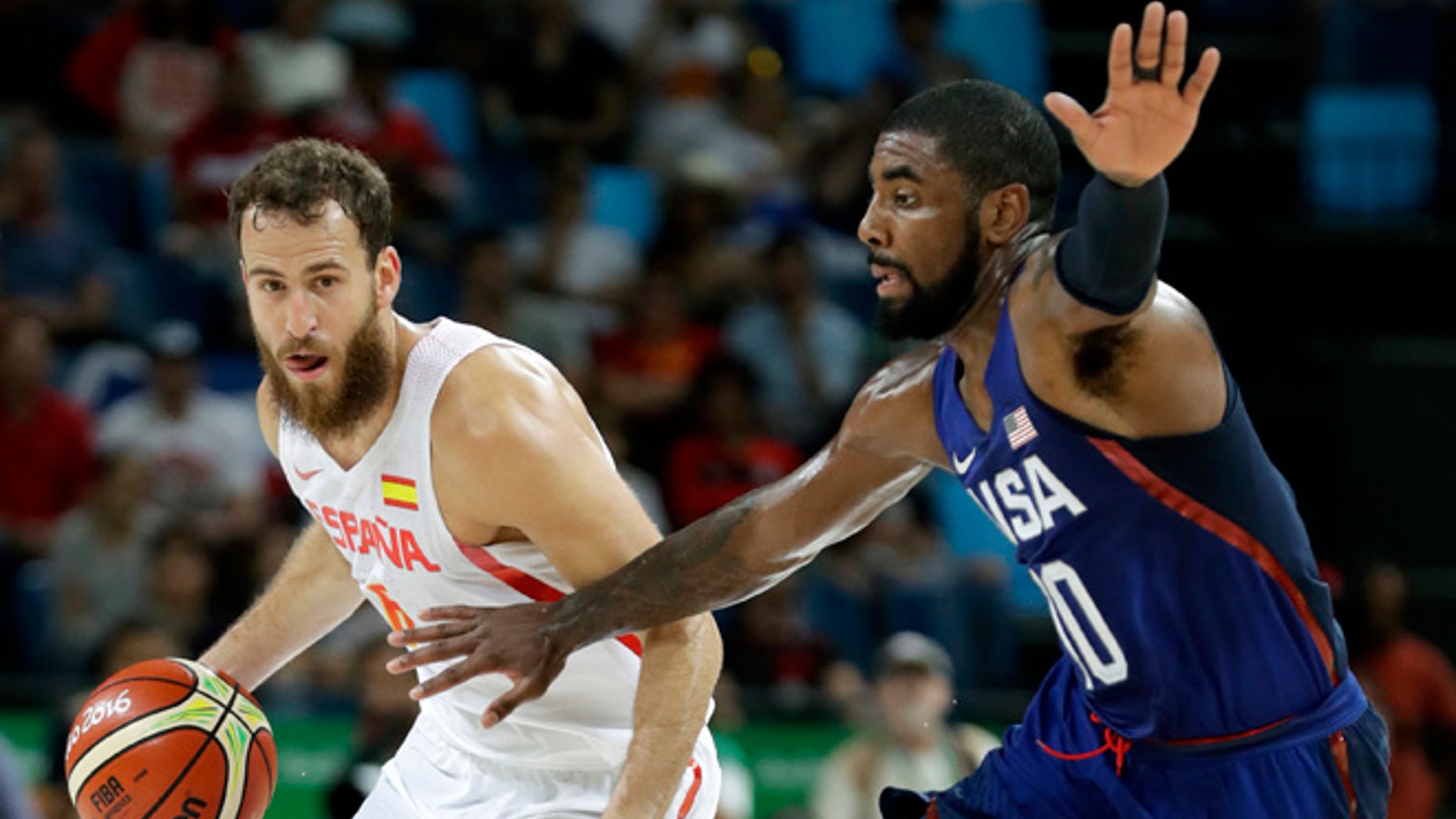 Spain's Sergio Rodriguez, left, drives up court past United States' Kyrie Irving, right, during a semifinal round basketball game at the 2016 Summer Olympics in Rio de Janeiro, Brazil, Friday, Aug. 19, 2016. (AP Photo/Charlie Neibergall)