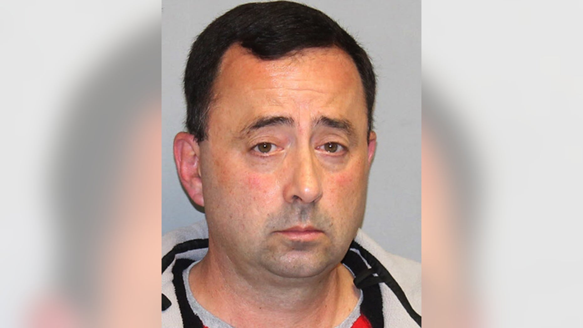 This Nov. 21, 2016 file photo provided by the Michigan Attorney General's office shows former USA Gymnastics team doctor Larry Nassar. Nassar, who has been accused of sexually abusing gymnasts, was hit with a new lawsuit filed in federal court in western Michigan on Tuesday, Jan. 10, 2017, by 18 women and girls who say they were molested by him, mostly at his clinic at Michigan State University. (Michigan Attorney General's office via AP, File)
