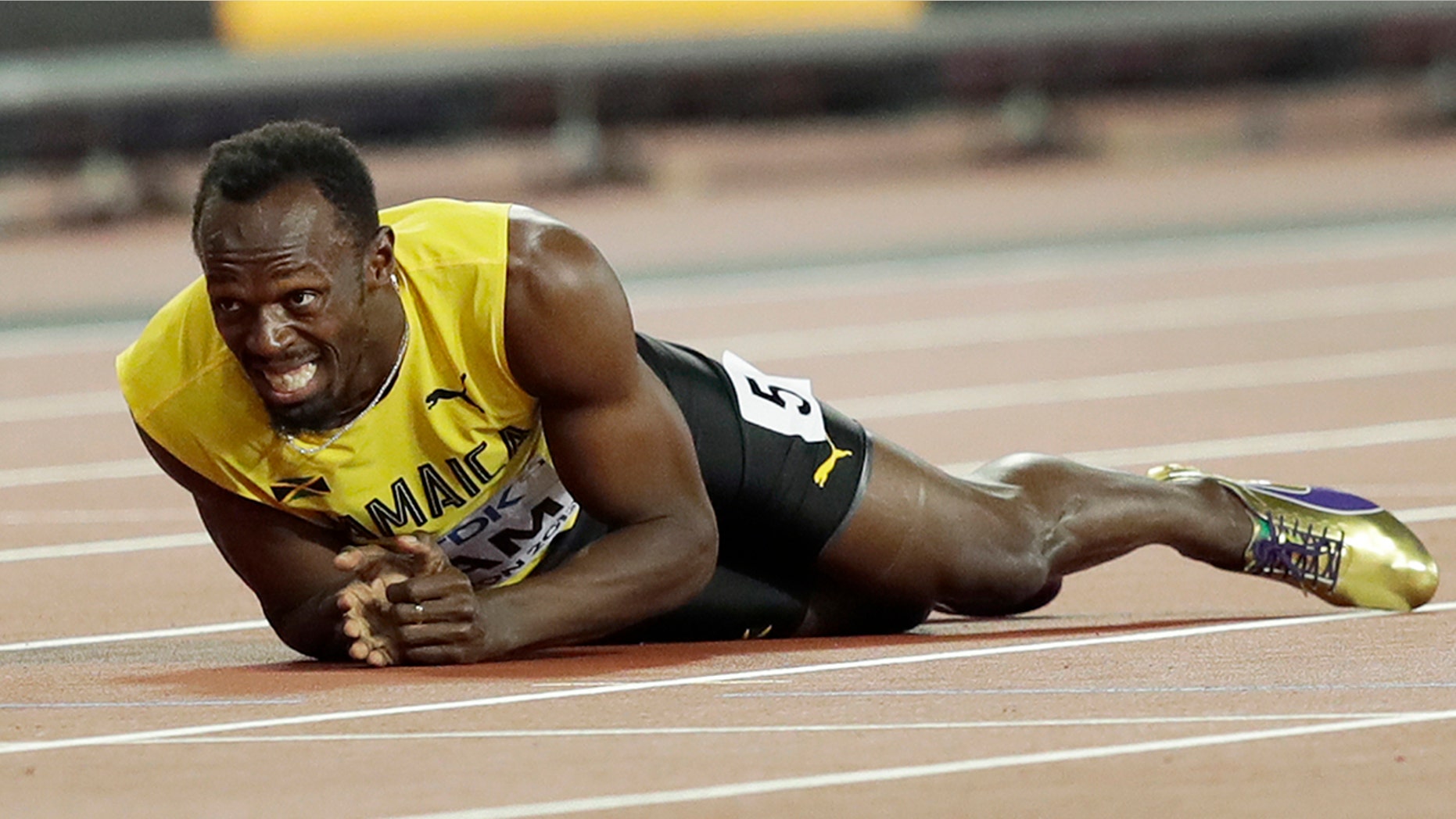 Jamaica's Usain Bolt lies on the track after he injured himself during the 4x100 m relay final during the World Athletics Championships in London Saturday.