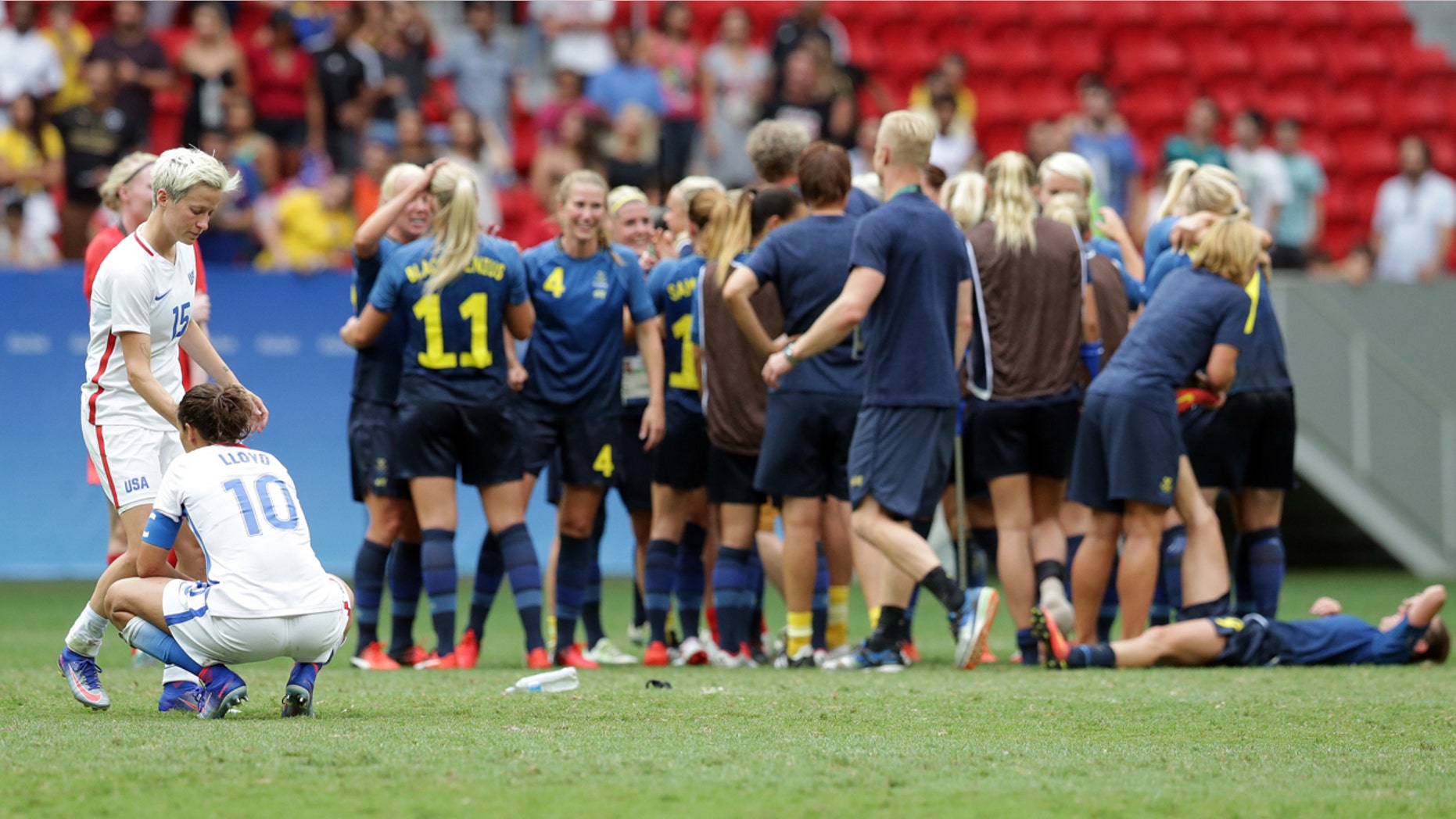 Aug. 12, 2016: United States' Megan Rapinoe and Carli Lloyd react as Sweden's players celebrate after a penalty shoot-out during a quarter-final match of the women's Olympic football tournament between the United States and Sweden in Brasilia