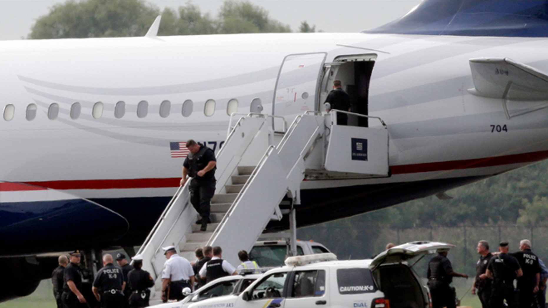 Sept. 6, 2012: Law enforcement officials work around a US Airways flight at Philadelphia International Airport, after the plane returned to the airport.