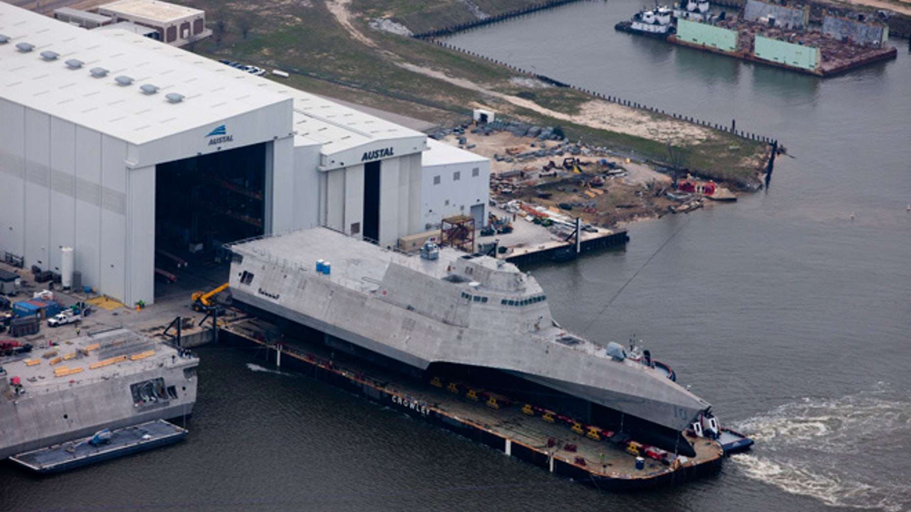 An aerial view of the future littoral combat ship USS Gabrielle Giffords (LCS 10) during its launch sequence at the Austal USA shipyard.