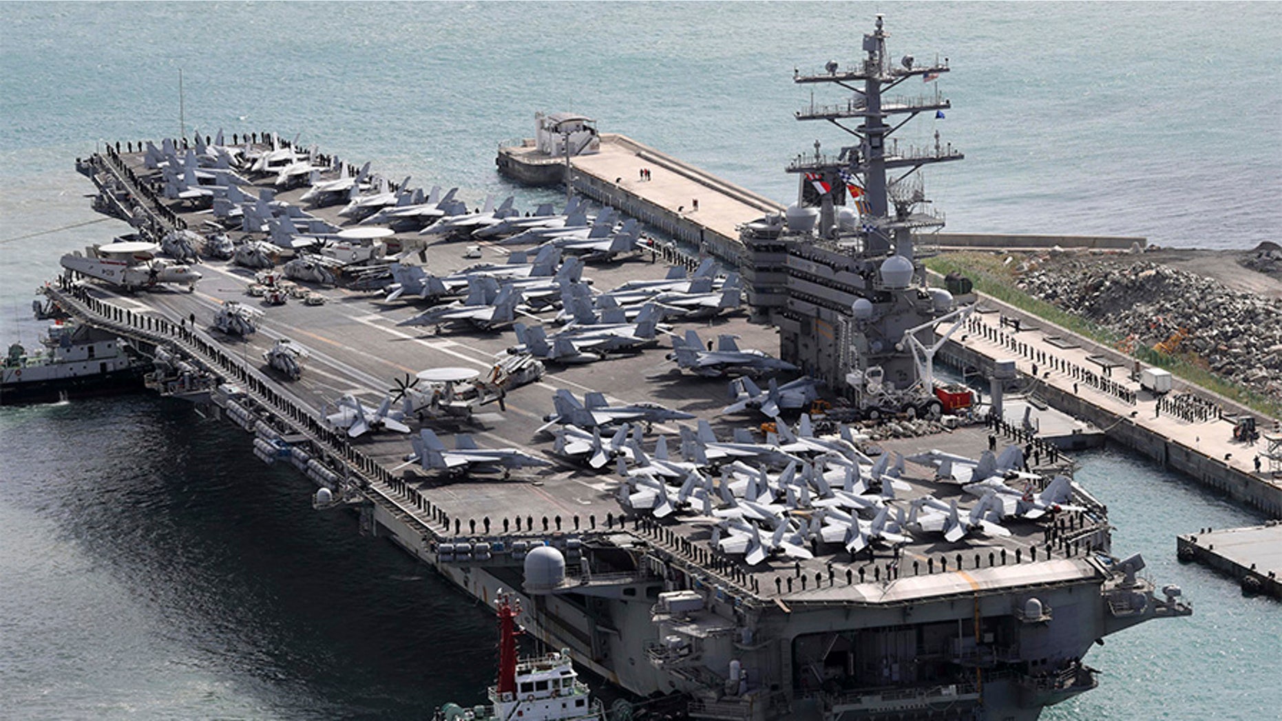 The aircraft carrier USS Ronald Reagan (CVN 76) is escorted into Busan port, South Korea, after completing a joint drill with the South Korean military, Saturday.